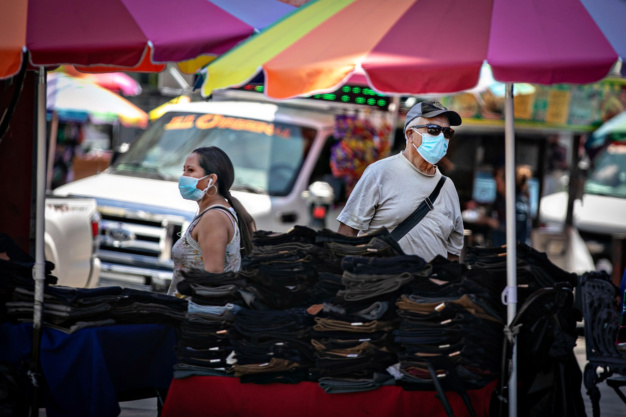 People wearing masks shop and work in Santee Ally in Loa Angeles on July 11, 2022.