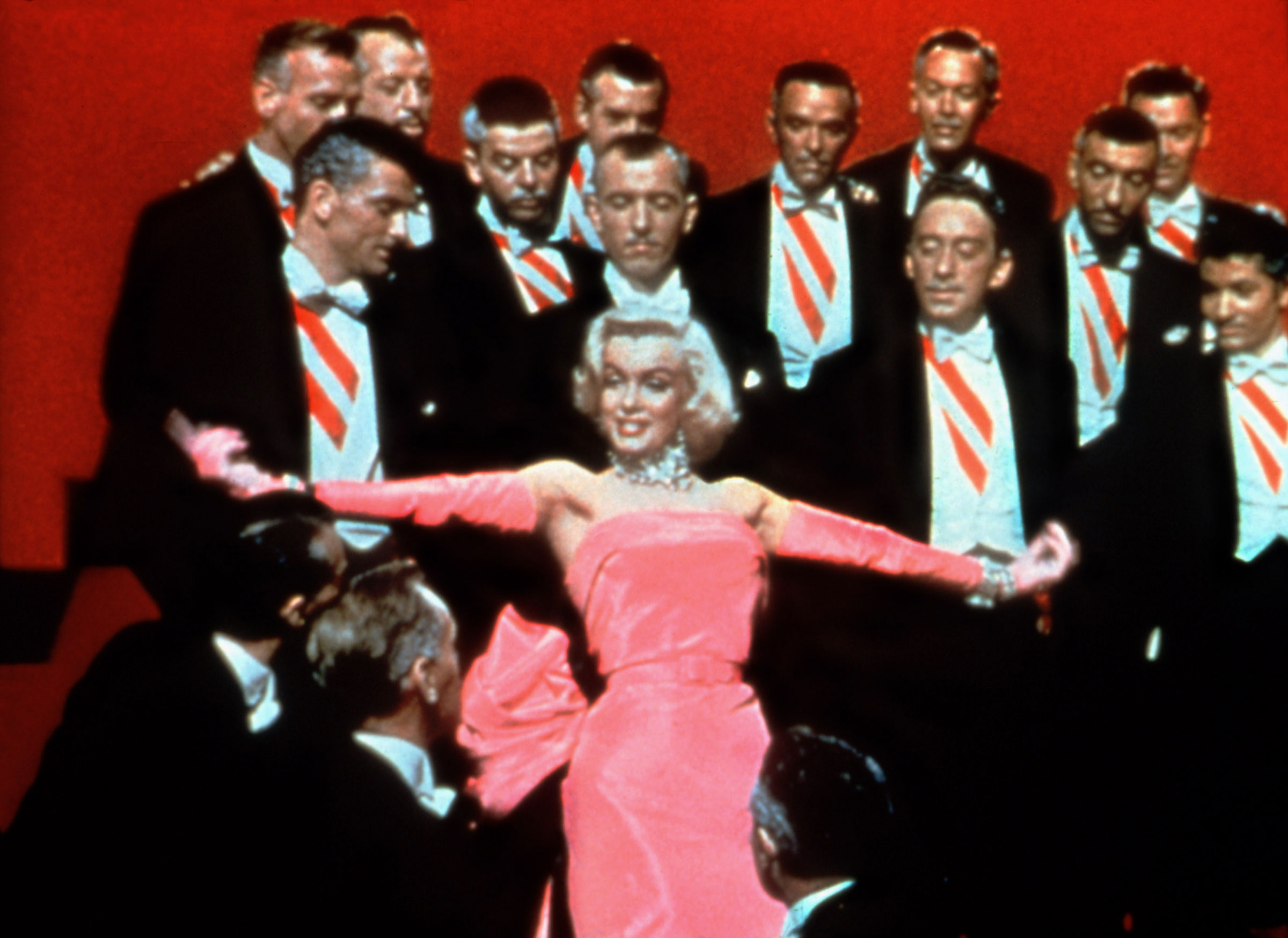 Marilyn Monroe wearing a pink dress in a still from GENTLEMEN PREFER BLONDES