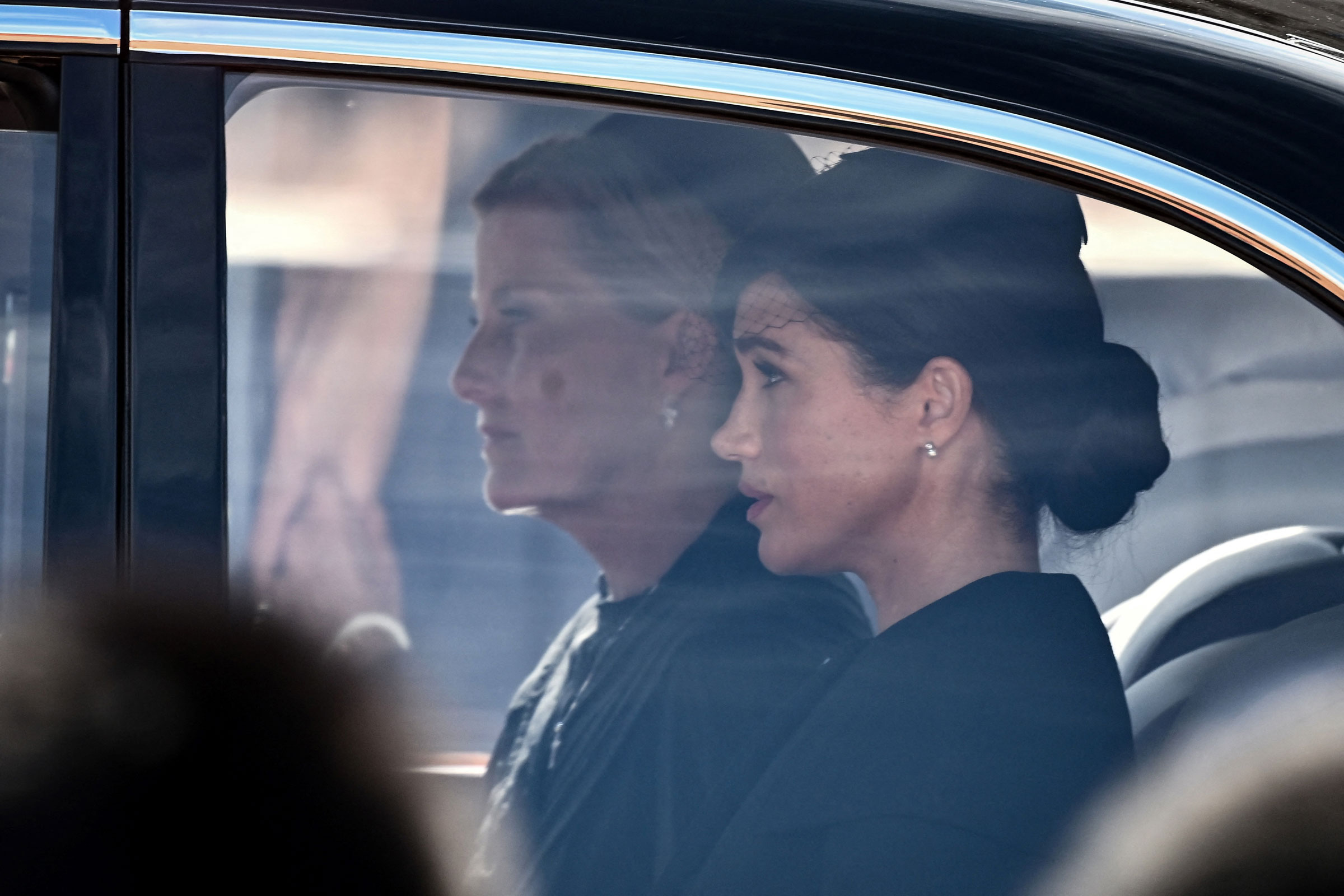 Britain's Sophie, Countess of Wessex (L) and Meghan, Duchess of Sussex are driven behind the coffin of Queen Elizabeth II