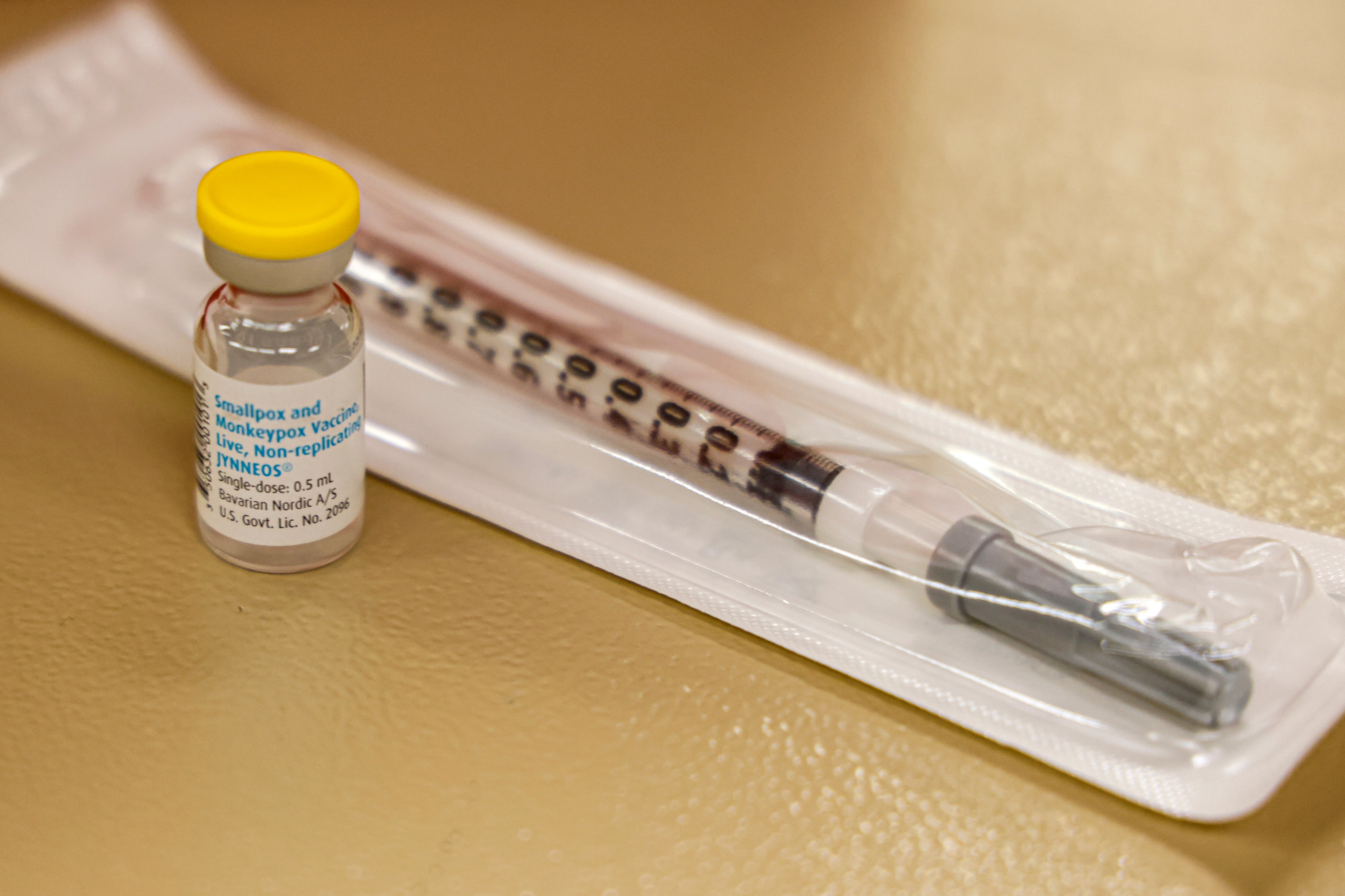 A vial containing the monkeypox vaccine and a syringe is set on the table at a vaccination clinic run by the Mecklenburg County Public Health Department in Charlotte, N.C. on Aug. 20, 2022. (Nell Redmond—AP Photo)