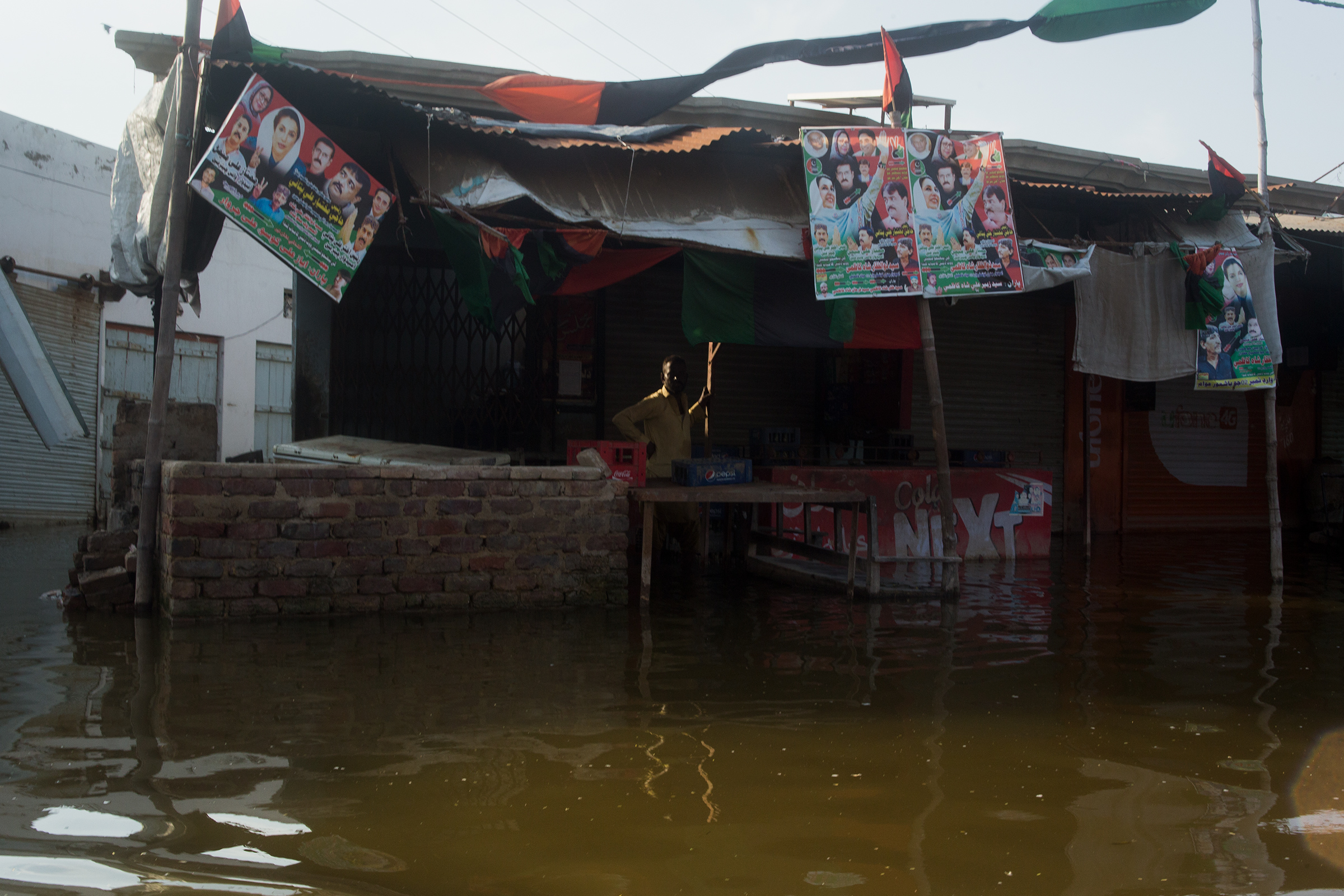 A shopkeeper in Hayat Khaskheli, Jhuddo, next to his flooded shop, September 9.  (Hassaan Gondal for TIME)