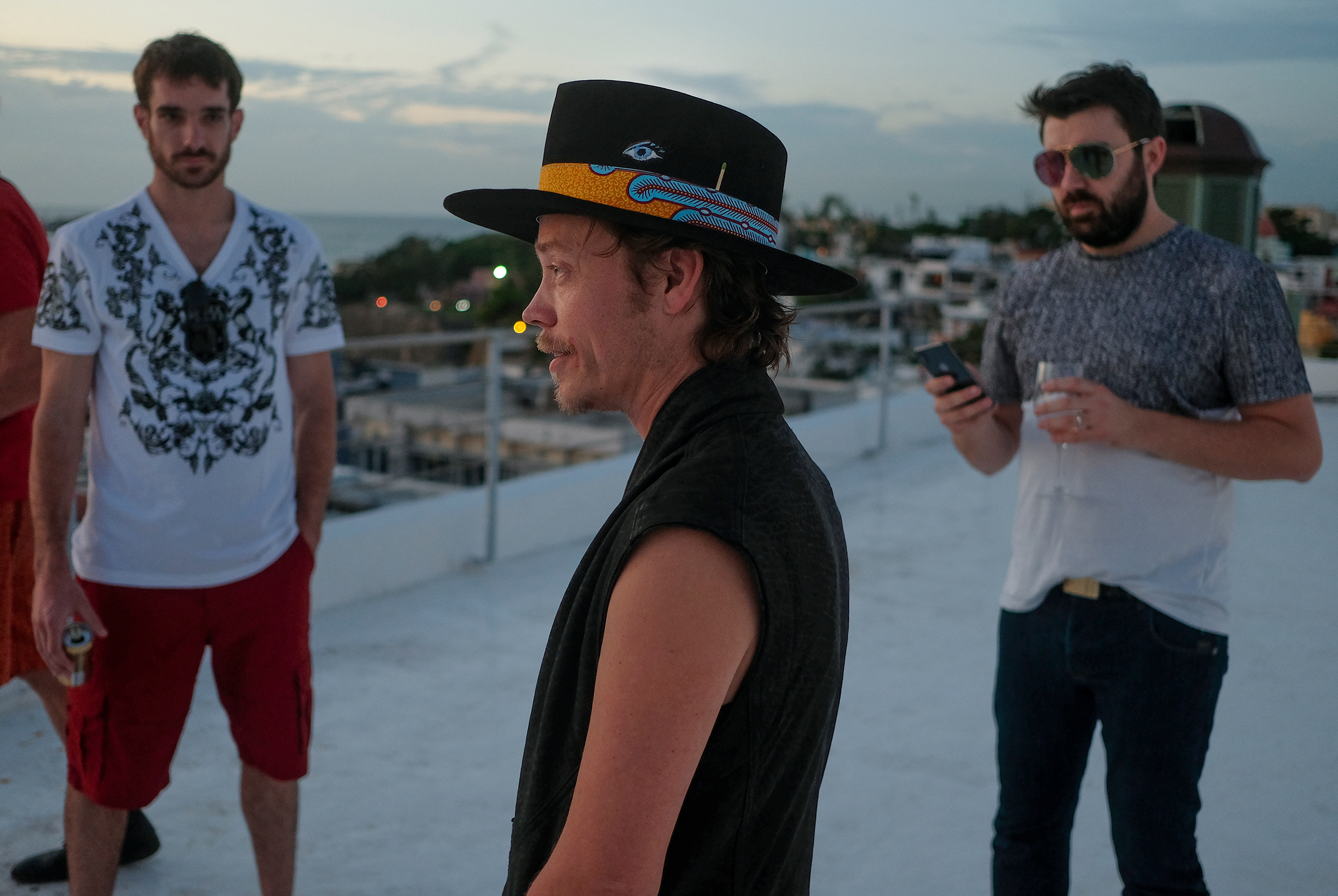 Brock Pierce, center, with Josh Boles, left, and Matt Clemenson on the roof of the Monastery Art Suites, which they rented out as a headquarters for their cryptocurrency business, in San Juan, Puerto Rico, January 2018. Dozens of entrepreneurs, made newly wealthy by virtual currencies, moved to the island to avoid taxes and to build a society that runs on blockchain. (José Jiménez-Tirado—The New York Times/Redux)