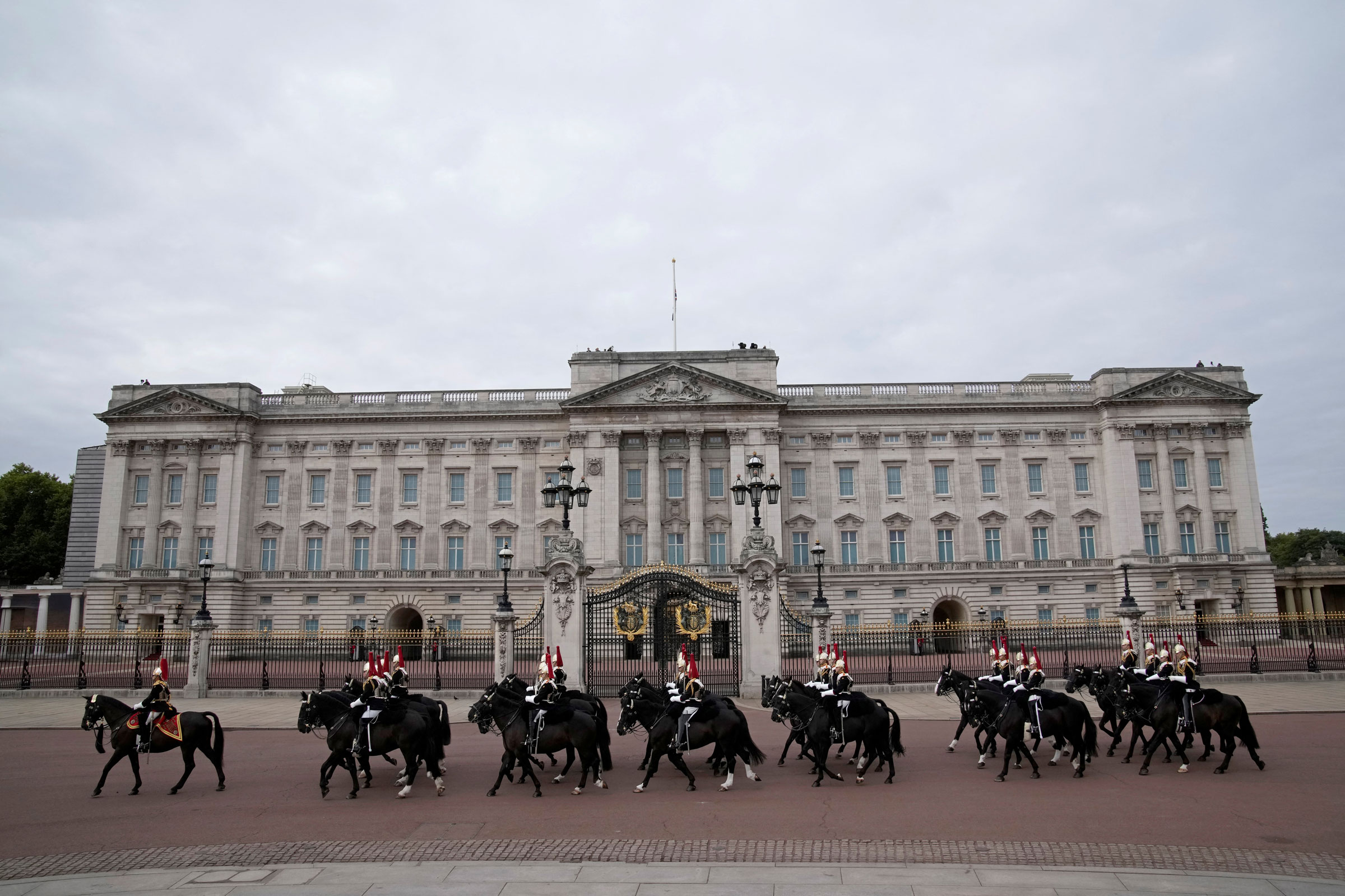 Soldiers on horseback ride past Buckingham Palace before Queen Elizabeth II’s funeral service at Westminster Abbey in central London.