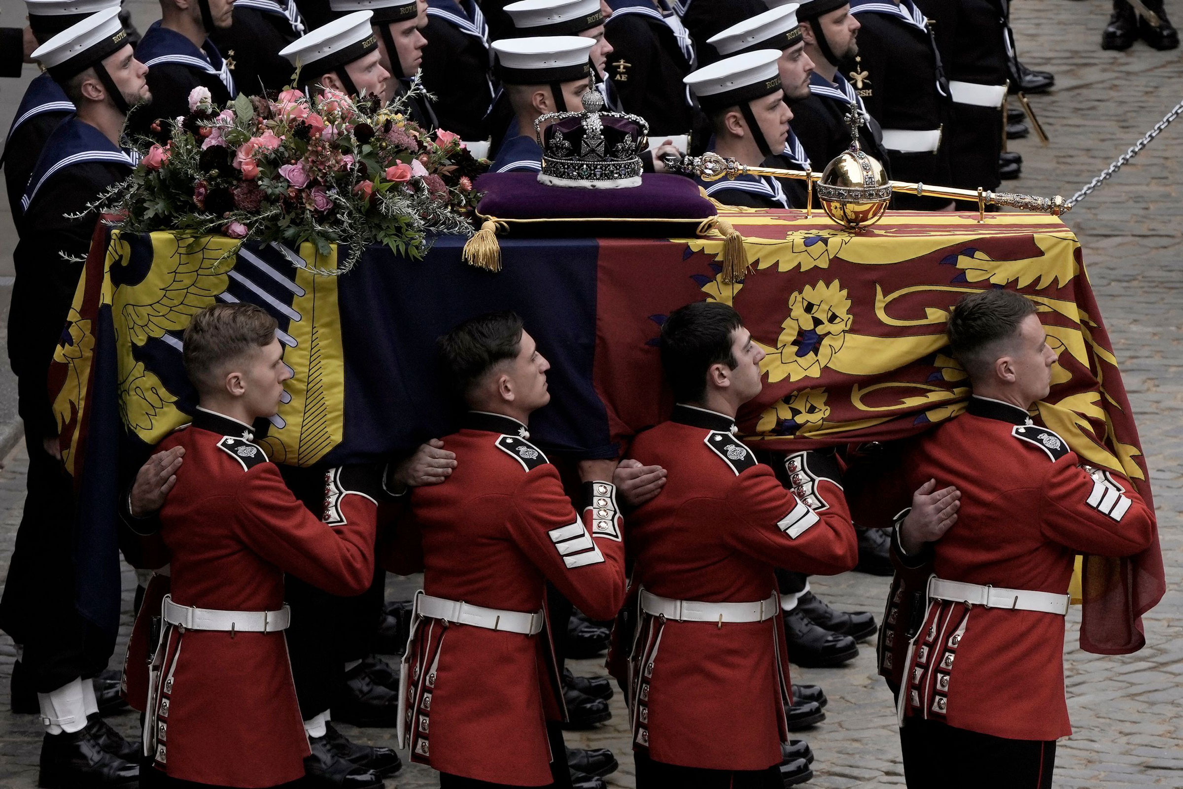 The coffin of Queen Elizabeth II is loaded onto a gun carriage pulled by Royal Navy soldiers to go from Westminster Hall for her funeral service in Westminster Abbey.