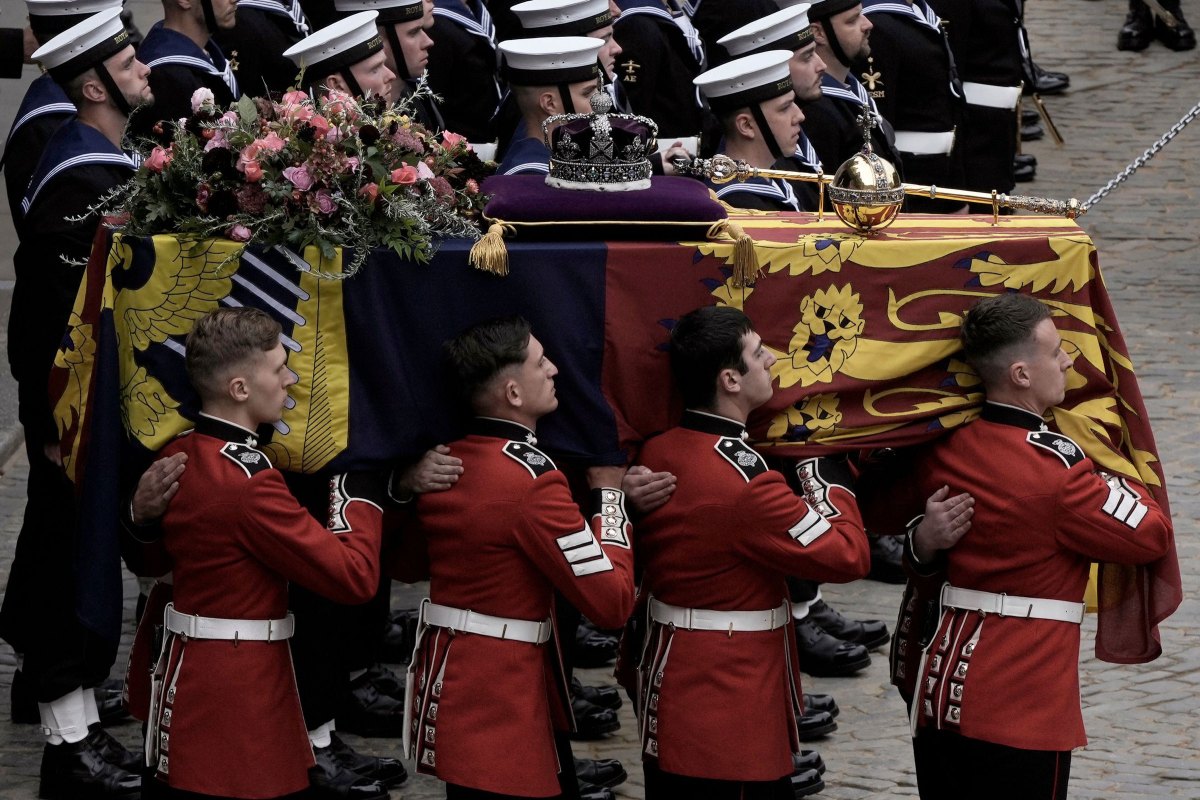 The coffin of Queen Elizabeth II is loaded onto a gun carriage pulled by Royal Navy soldiers to go from Westminster Hall for her funeral service in Westminster Abbey.