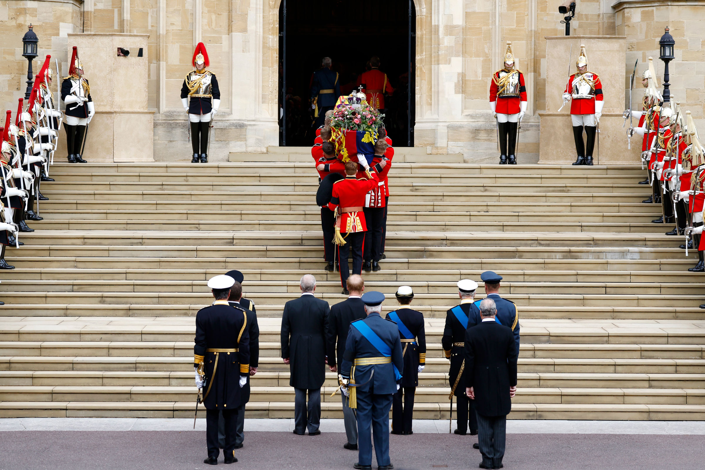 Pall bearers carry the coffin of Queen Elizabeth II with the Imperial State Crown resting on top into St. George's Chapel at Windsor Castle. (Jeff J Mitchell—Getty Images)