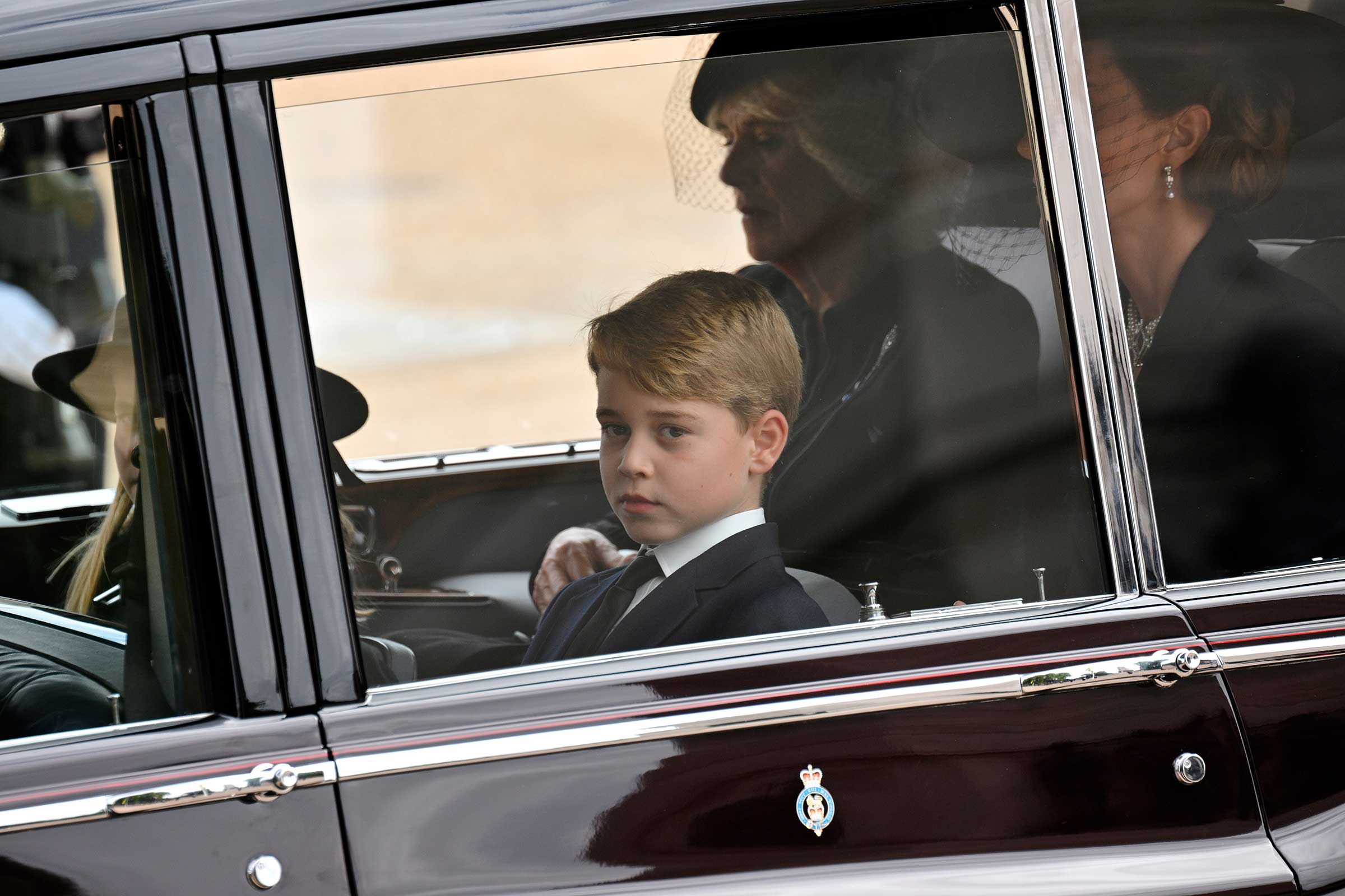 Prince George of Wales follow by car the coffin of Queen Elizabeth II as it travels from Westminster Abbey to Wellington Arch during the State Funeral Service of Britain's Queen Elizabeth II, Monday, Sept. 19, 2022, in London. (Loic Venance—Pool Photo/AP)