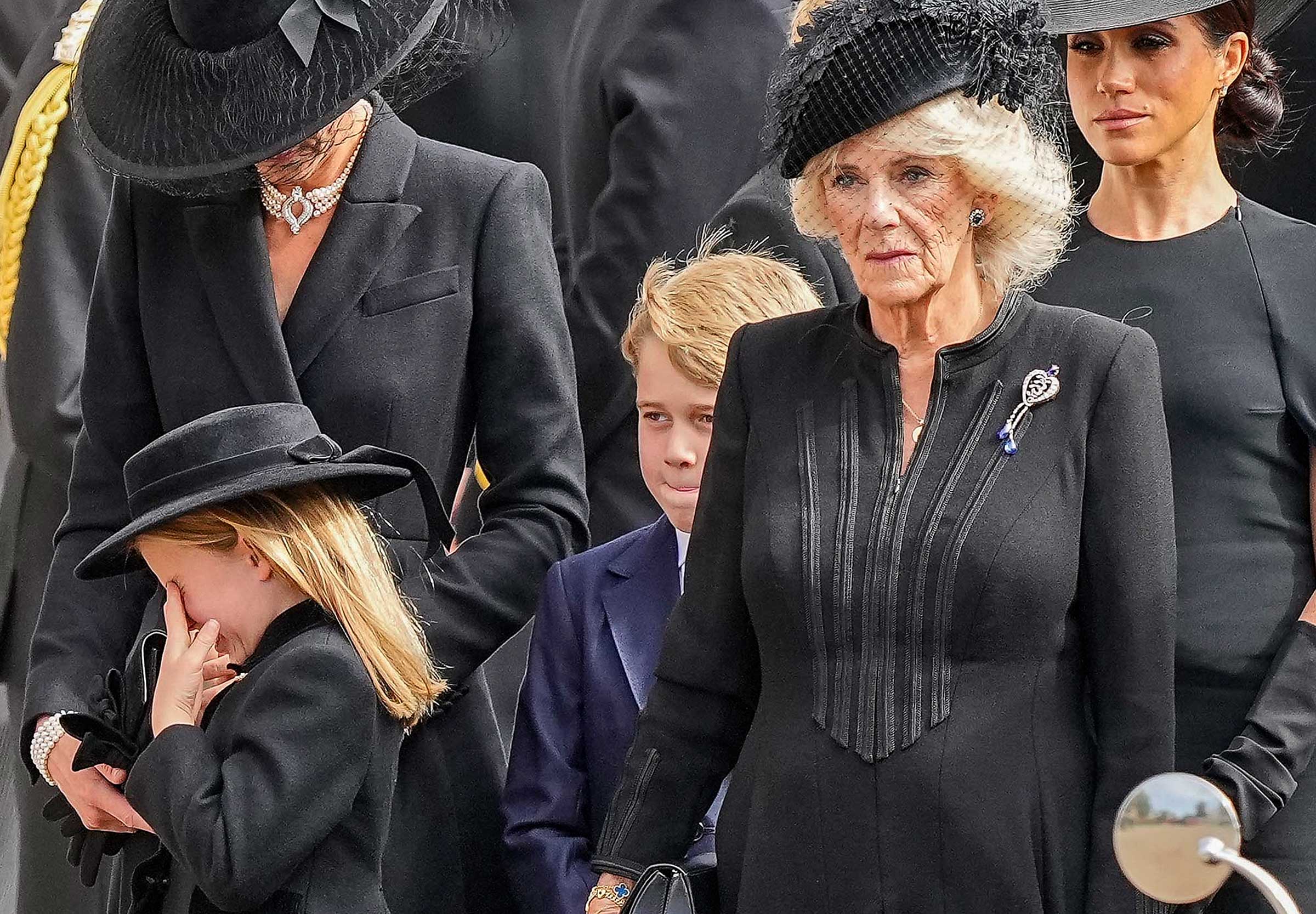 Kate, Princess of Wales, Princess Charlotte, Prince George, Camilla, the Queen Consort and Meghan, Duchess of Sussex follow the coffin of Queen Elizabeth II following her funeral service in Westminster Abbey in central London Monday Sept. 19, 2022. (Martin Meissner—Pool/AP)