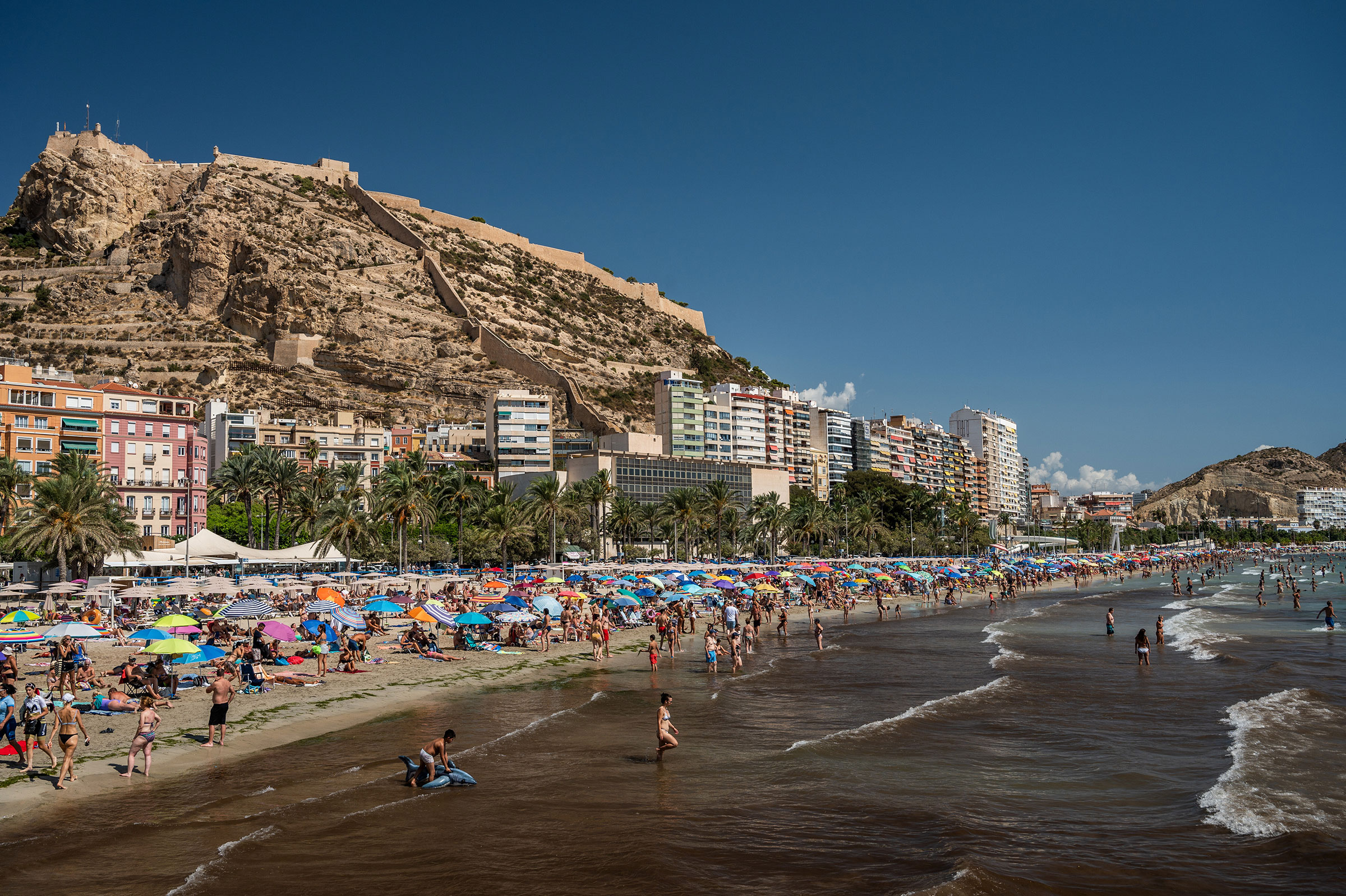 Tourists and locals crowd El Postiguet Beach on a hot August day in Alicante, Spain. (Marcos del Mazo—Lightrocket/Getty Images)