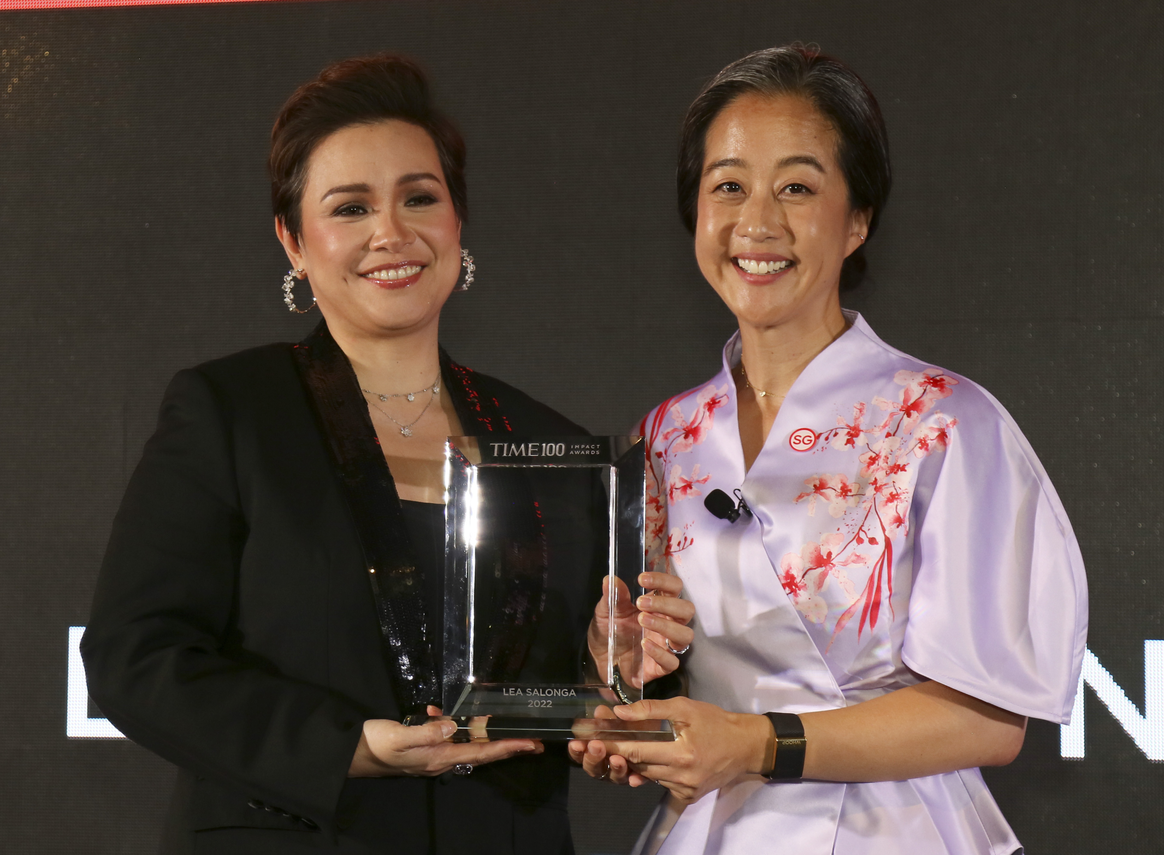 TIME Chief People Officer Sue Suh, right, presents singer and actor Lea Salonga, left, with a TIME100 Impact Award on Oct. 02, 2022 in Singapore. (Ore Huiying—Getty Images for TIME)