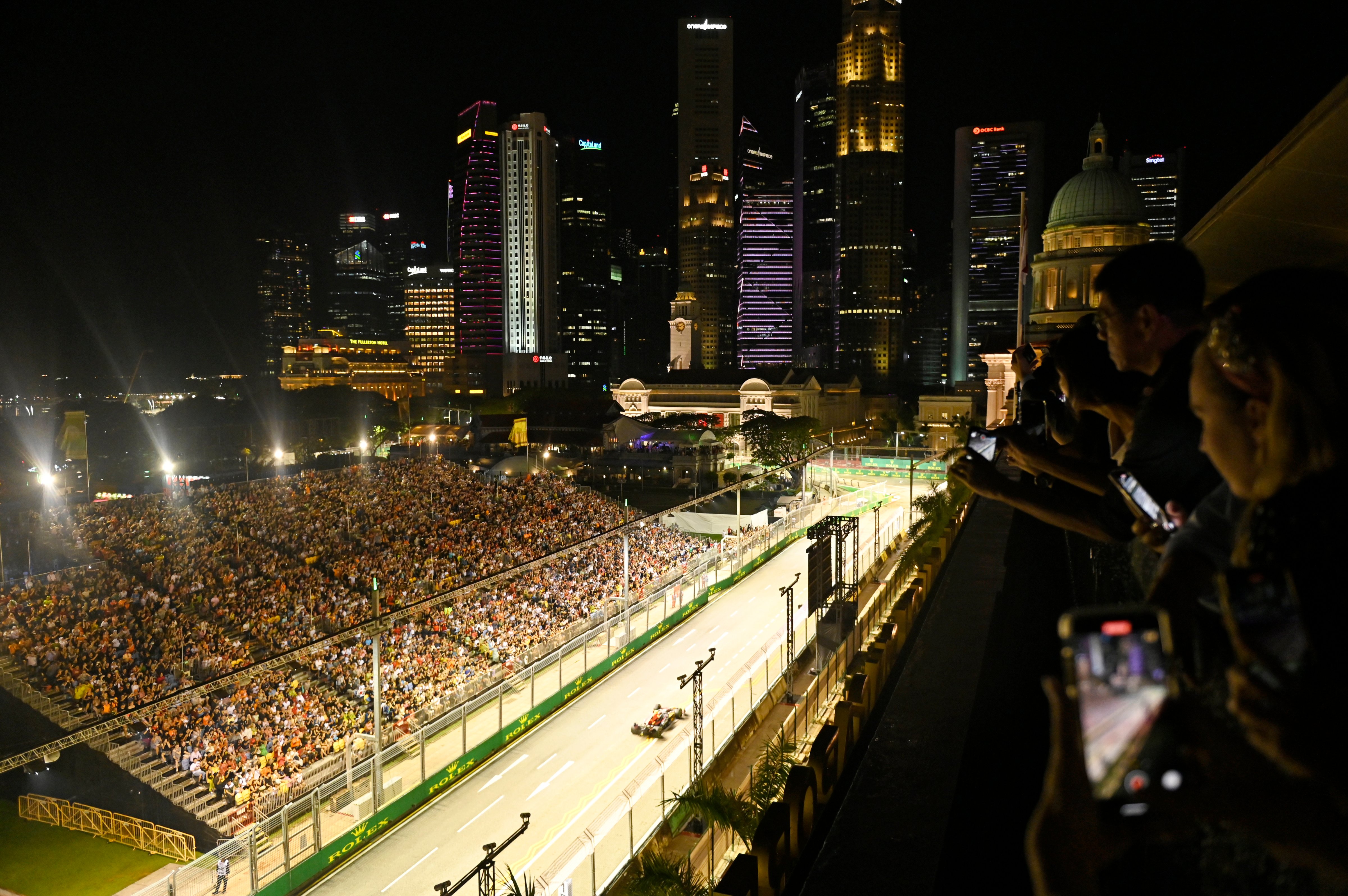 Guests of the TIME100 Impact Awards watch the Singapore F1 Grand Prix on Oct. 02, 2022 in Singapore. (Edwin Koo—Getty Images for TIME)