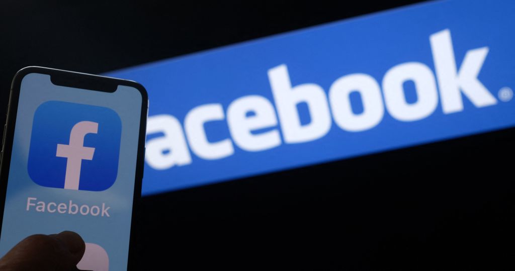 This illustration photo shows the Facebook logo on a smartphone in front of a computer screen in Los Angeles on August 12, 2021. (Chris Delmas—AFP/Getty Images)