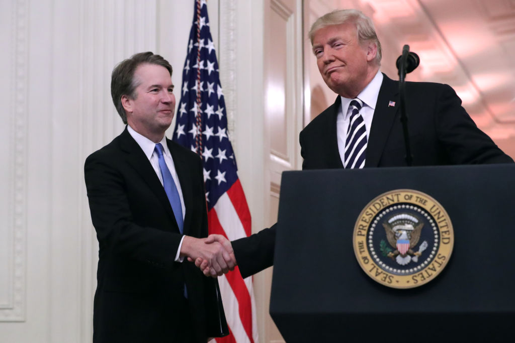 Supreme Court Justice Brett Kavanaugh shakes hands with President Donald Trump during Kavanaugh's ceremonial swearing in on October 08, 2018, in the White House in Washington, DC. (Chip Somodevilla—Getty Images)