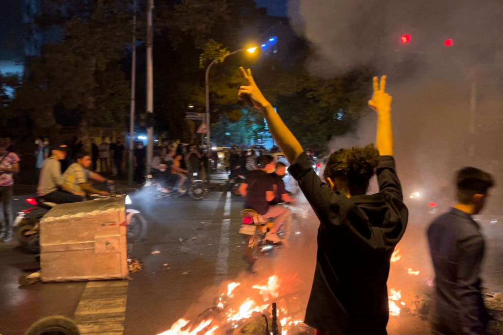 A picture obtained by AFP shows shows a demonstrator raising his arms and makes the victory sign during a protest for Mahsa Amini, a woman who died after being arrested by the Islamic republic's "morality police," in Tehran on Sept. 19, 2022. (AFP via Getty Images)