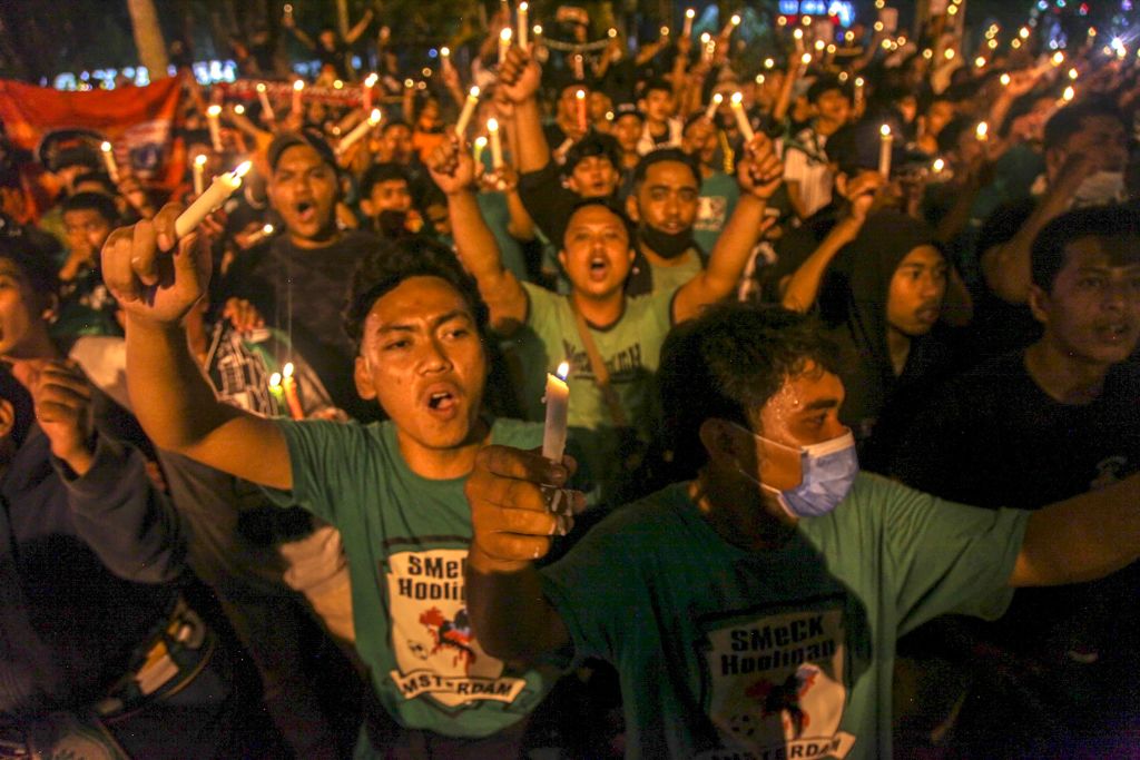 Indonesians hold a candlelight vigil for victims of a stampede, in Medan on Oct. 3, 2022. (ARIANDI—AFP/Getty Images)