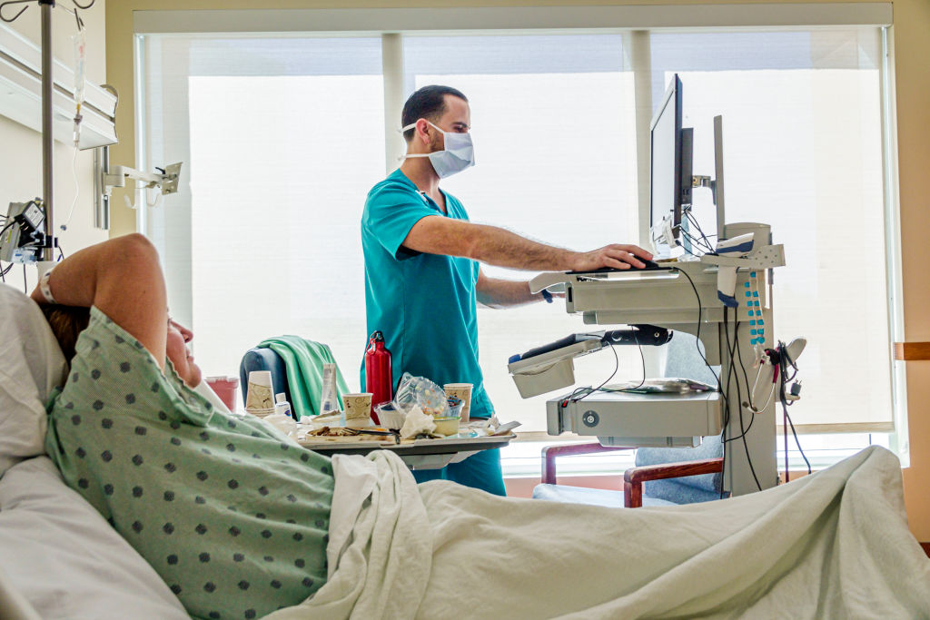 Miami Beach, Florida, Mount Sinai Medical Center, patient with male man RN nurse. (Jeffrey Greenberg-UCG/Universal Images Group)