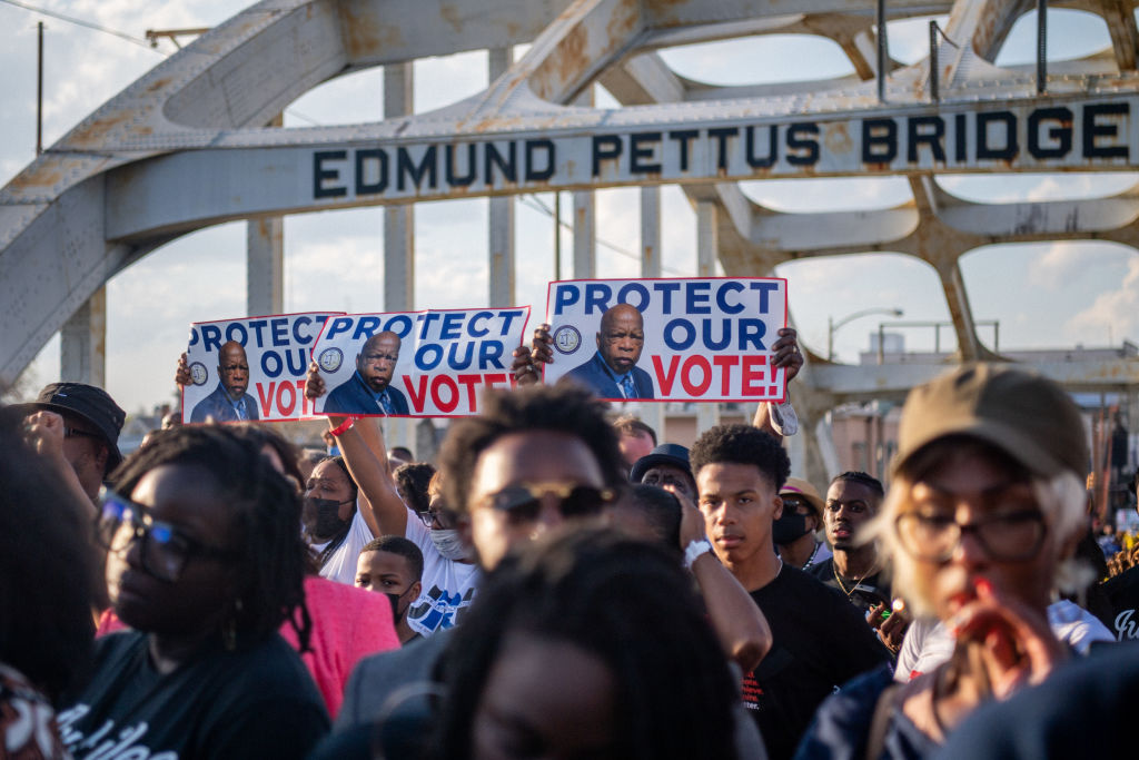 People march across the Edmund Pettus Bridge during commemorations for the 57th anniversary of "Bloody Sunday" on March 06, 2022 in Selma, Alabama. The bridge was the site of the brutal beatings of civil rights marchers at the hands of police during the first march for voting rights on March 7, 1965. (Brandon Bell—Getty Images)