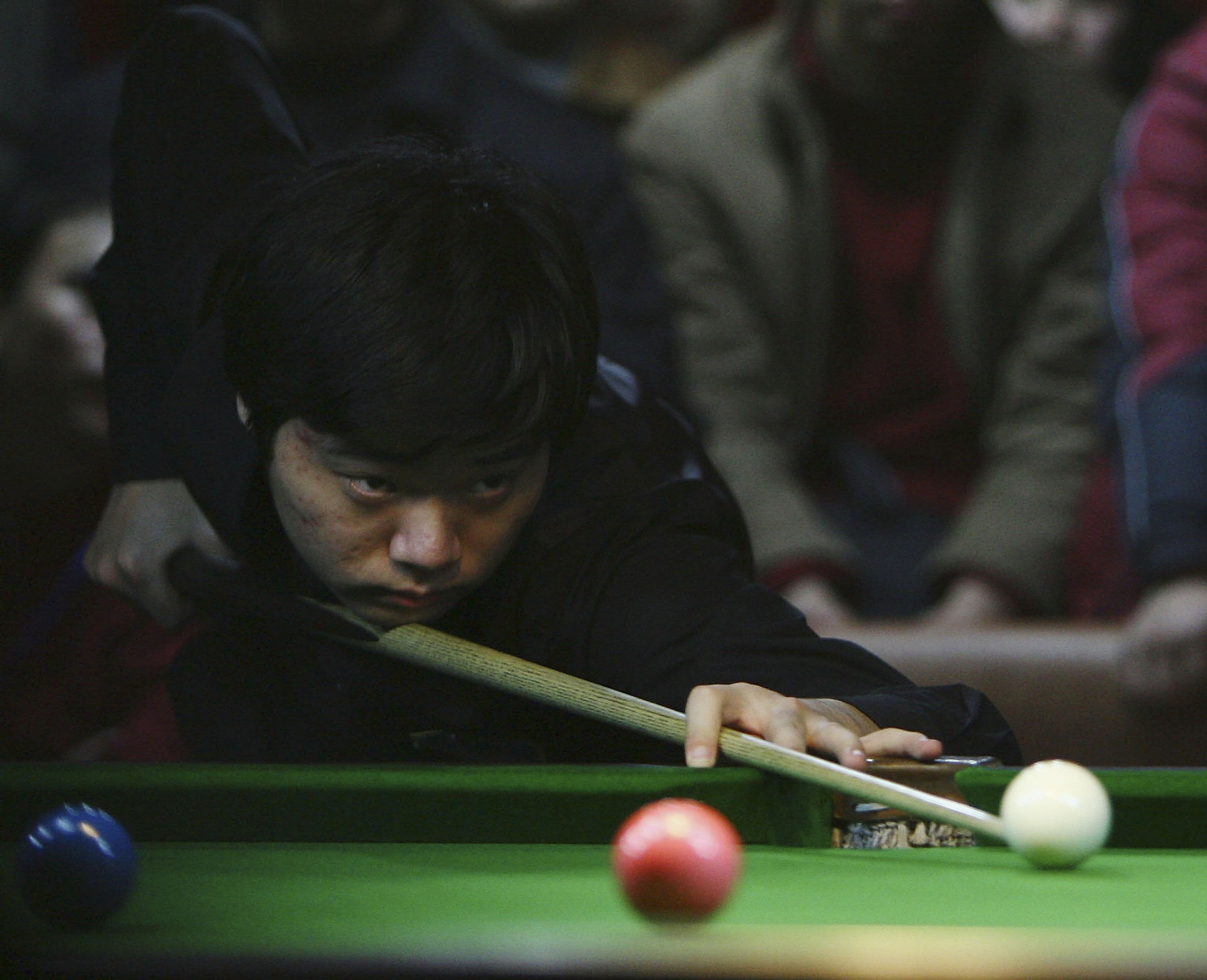 Newly-crowned U.K. champion Ding Junhui of China plays a shot during the 2005 China National Professional Billiards Ranking Tournament in Nanjing, Jiangsu Province, China, on Dec. 22, 2005. (China Photos/Getty Images)