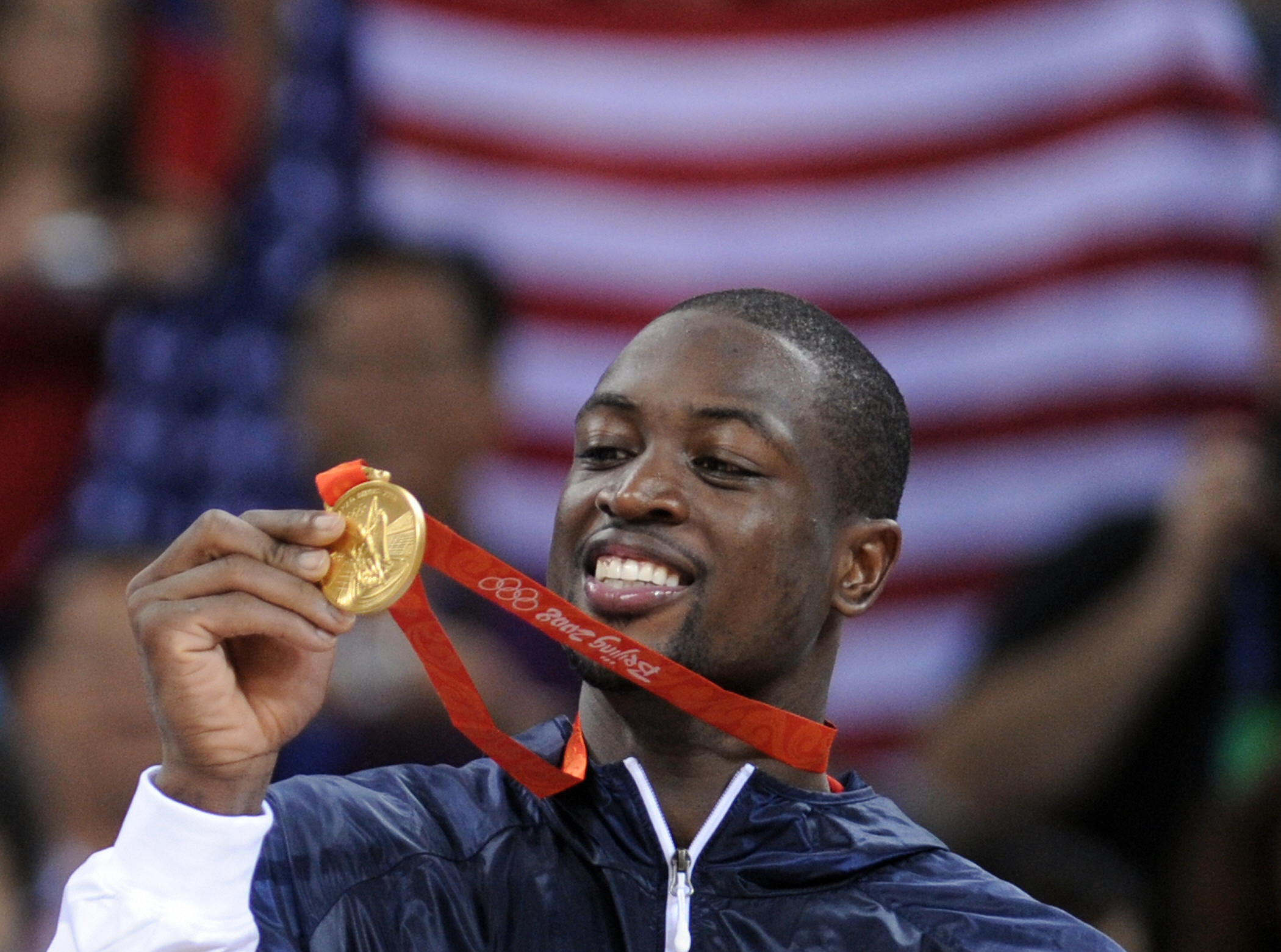 USA's Dwyane Wade shows his medals on the podium after the men's basketball gold medal match of the Beijing 2008 Olympic Games on August 24, 2008 at the Olympic basketball Arena in Beijing. The United States won the Olympic men's basketball gold medal defeating Spain 118-107. (FILIPPO MONTEFORTE/AFP via Getty Images)