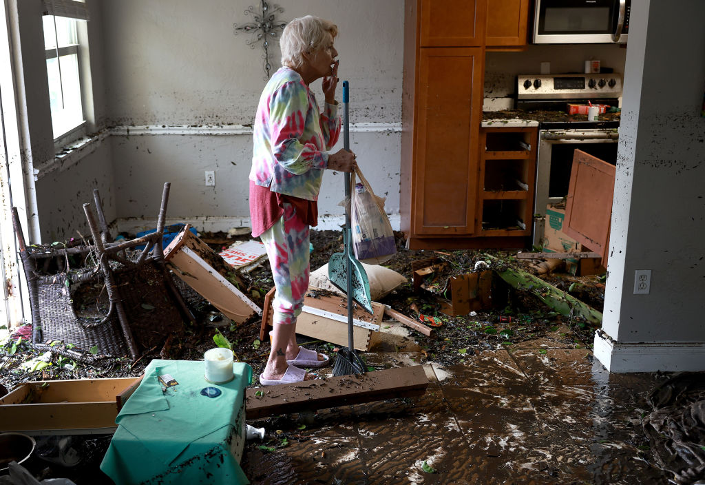 Stedi Scuderi looks over her apartment after flood water inundated it when Hurricane Ian passed through the area on September 29, 2022 in Fort Myers, Florida. (Joe Raedle—Getty Images)