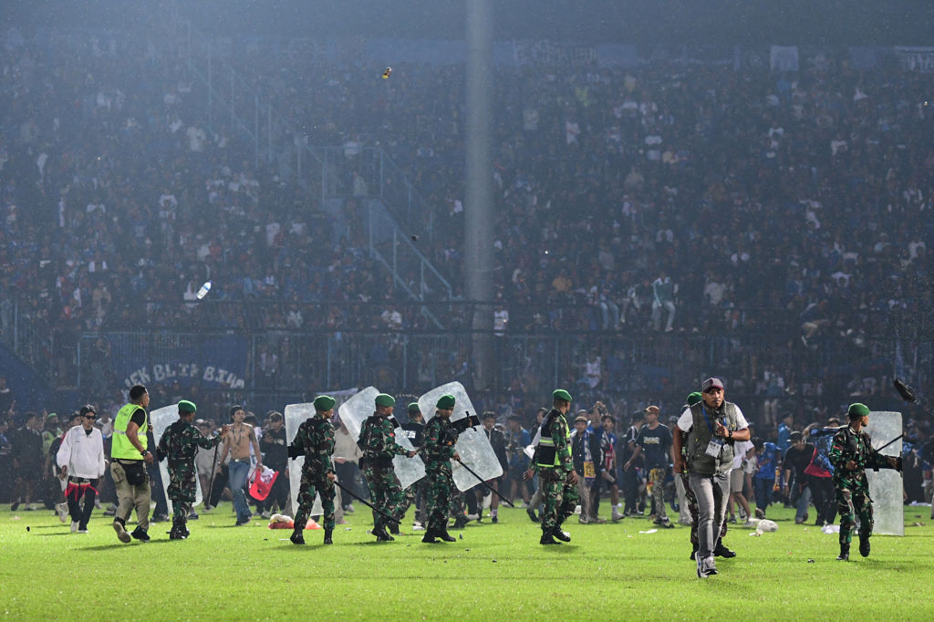 This picture shows members of the Indonesian army securing the pitch after a football match between Arema FC and Persebaya Surabaya at Kanjuruhan stadium in Malang, East Java, on Oct. 1, 2022. (STR—AFP/ Getty Images)