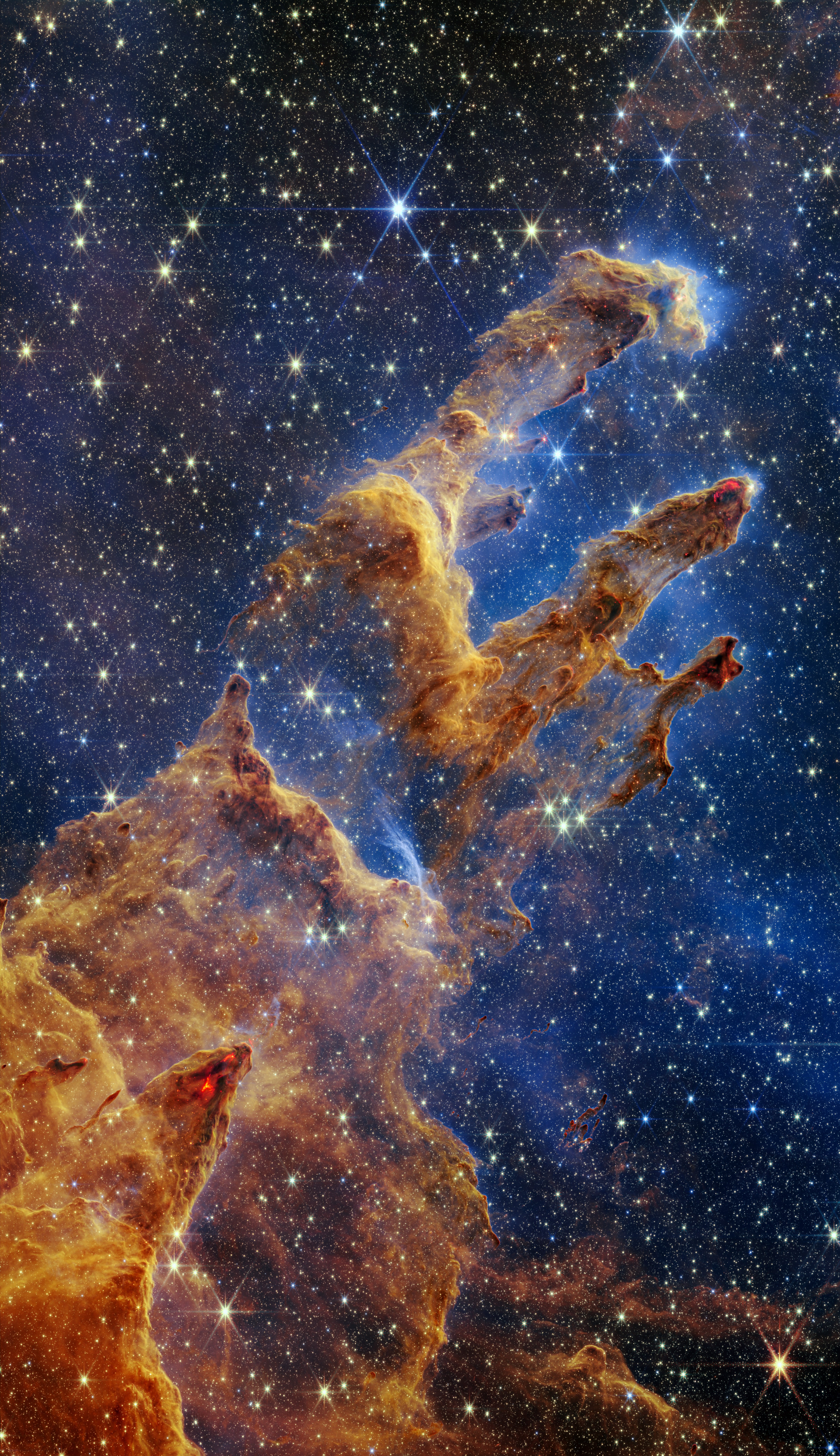 The Pillars of Creation are set off in a kaleidoscope of color in NASA’s James Webb Space Telescope’s near-infrared-light view. (NASA, ESA, CSA, STScI, and Alyssa Pagan (STScI); Public)