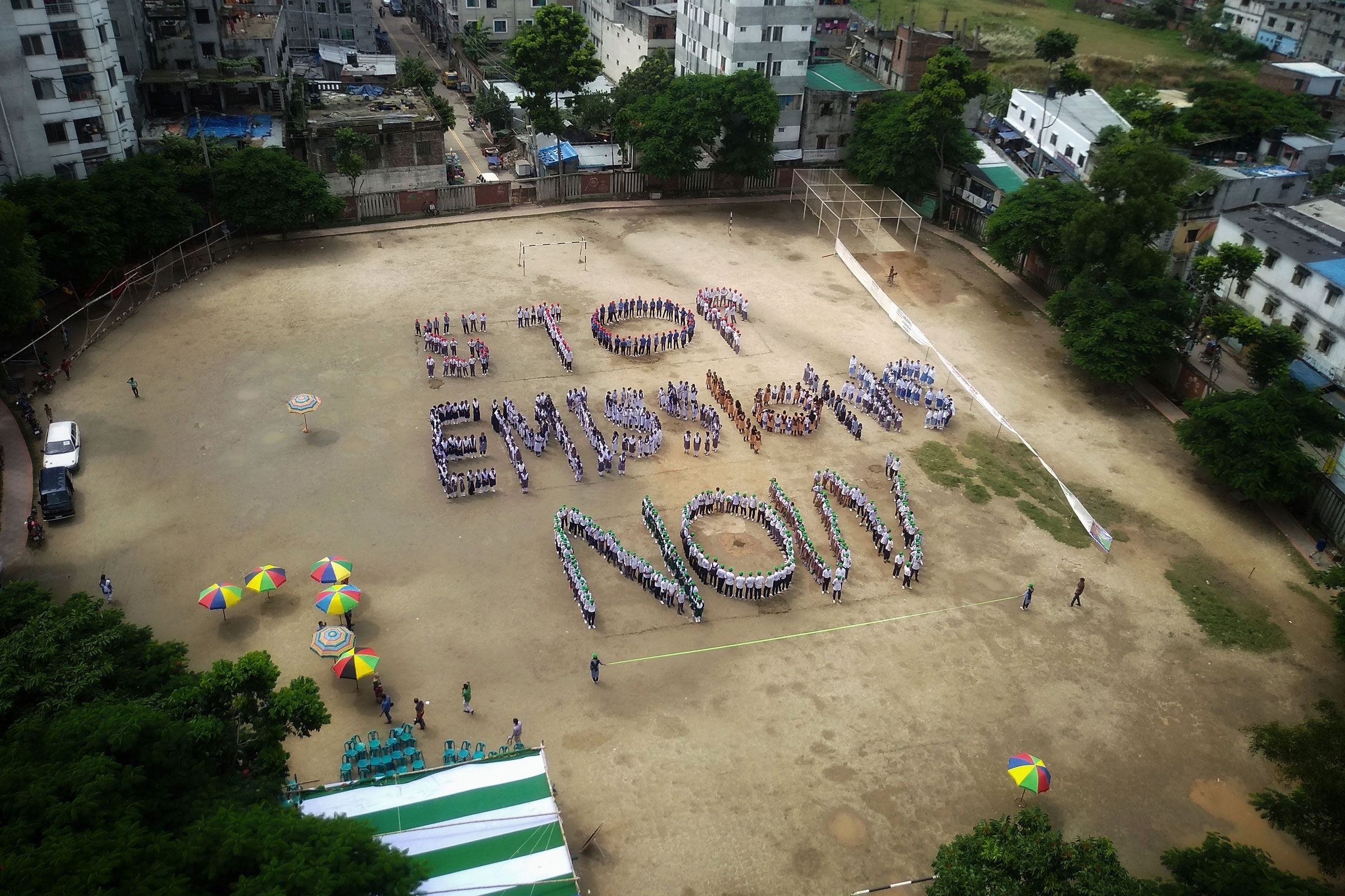 Students create a Human Formation to spell out the words "Stop Emissions Now" to demand strong action on the climate crisis in Dhaka, Bangladesh on 14 September 2019. (Syed Mahamudur Rahman—NurPhoto/Getty)