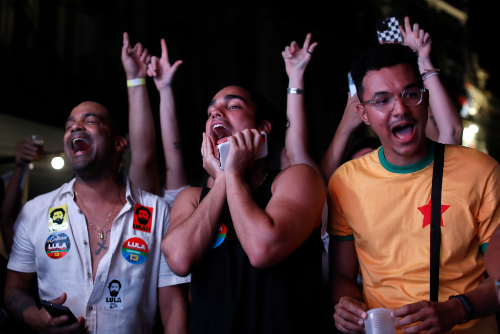 Supporters of Luiz Inácio Lula da Silva of Workers' Party cheer for their candidate during vote count in Largo Da Prainha area on presidential runoff day on Oct. 30, 2022 in Rio de Janeiro, Brazil. (Joao Laet—Getty Images)