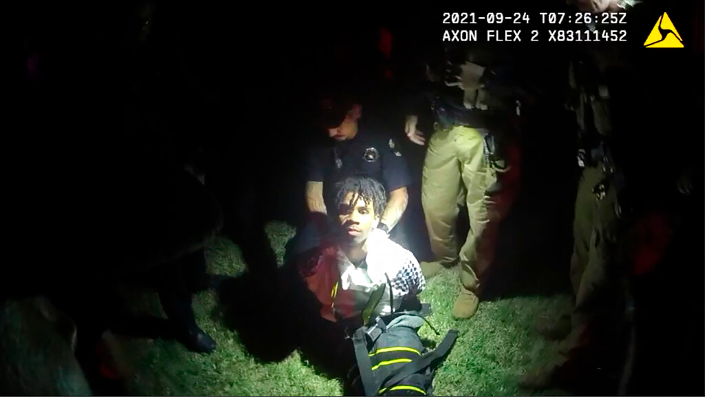 In this image from body camera video provided by Sedgwick County, police put Cedric "C.J." Lofton, 17, into a body-length restraining device called a WRAP outside his home in Wichita, Kan., on Sept. 24, 2021. The death of the Black teenager at a Kansas juvenile detention center was foreshadowed five years earlier by a state inspection of the facility that noted systemic deficiencies in its handling of children with mental health issues, according to a federal civil rights lawsuit filed June 13, 2022. (Sedgwick County/AP)