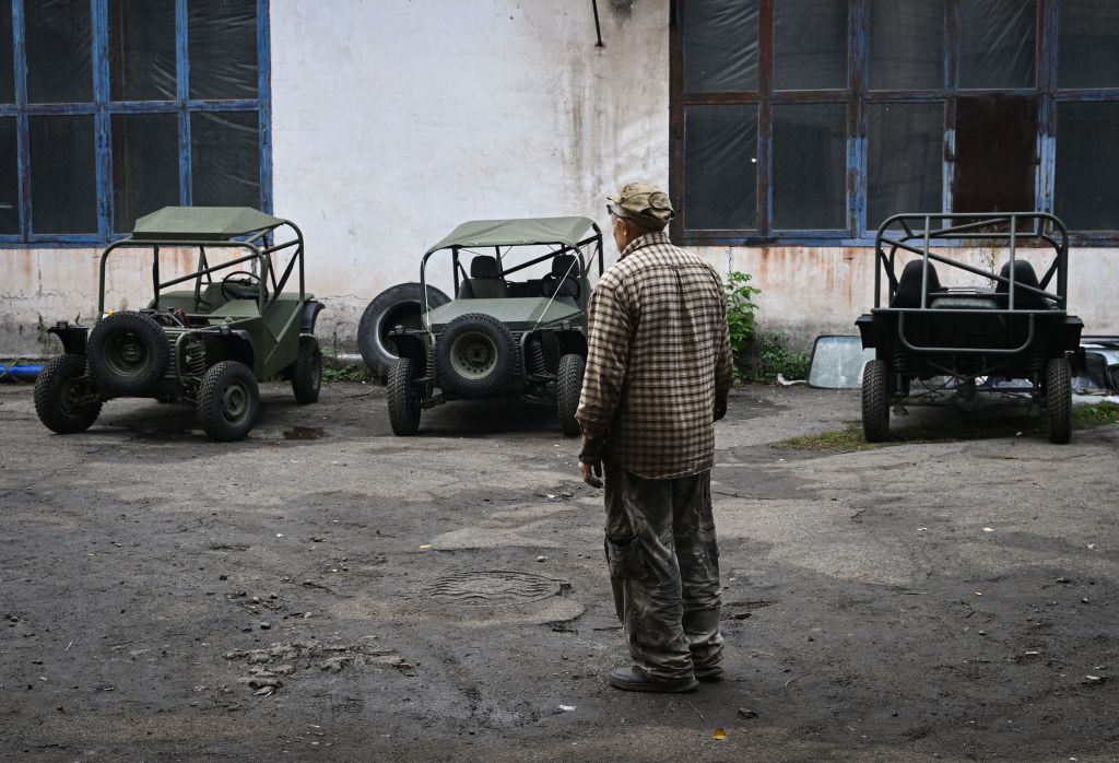 A worker looks at newly assembled buggies next to a workshop in Kryvyi Rih on September 29, 2022, amid the Russian invasion of Ukraine. (Genya Savilov—AFP/Getty Images)