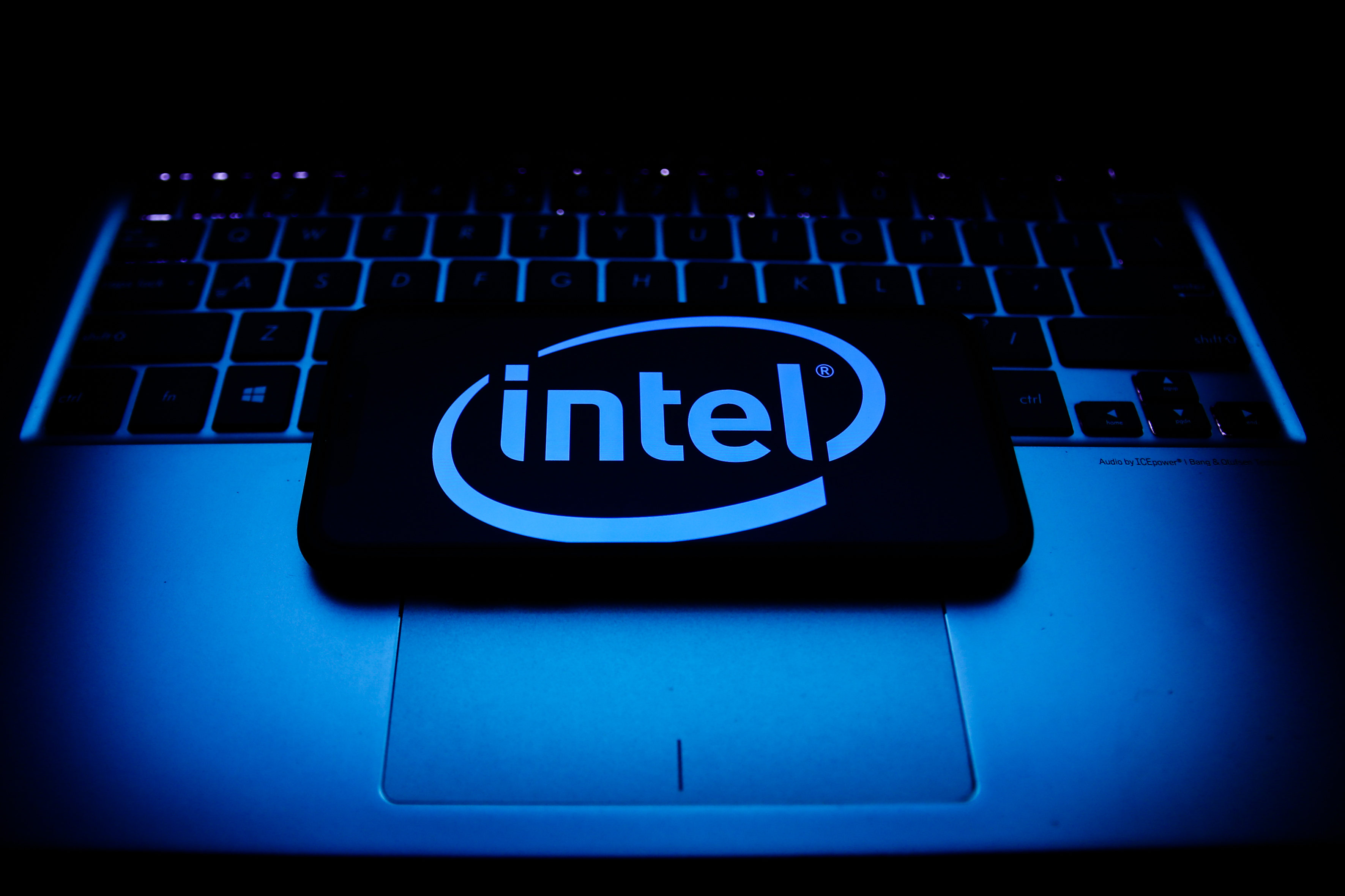 Intel logo displayed on a phone screen and a laptop keyboard are seen in this illustration photo taken in Krakow, Poland. (Jakub Porzycki-NurPhoto / Getty Images)