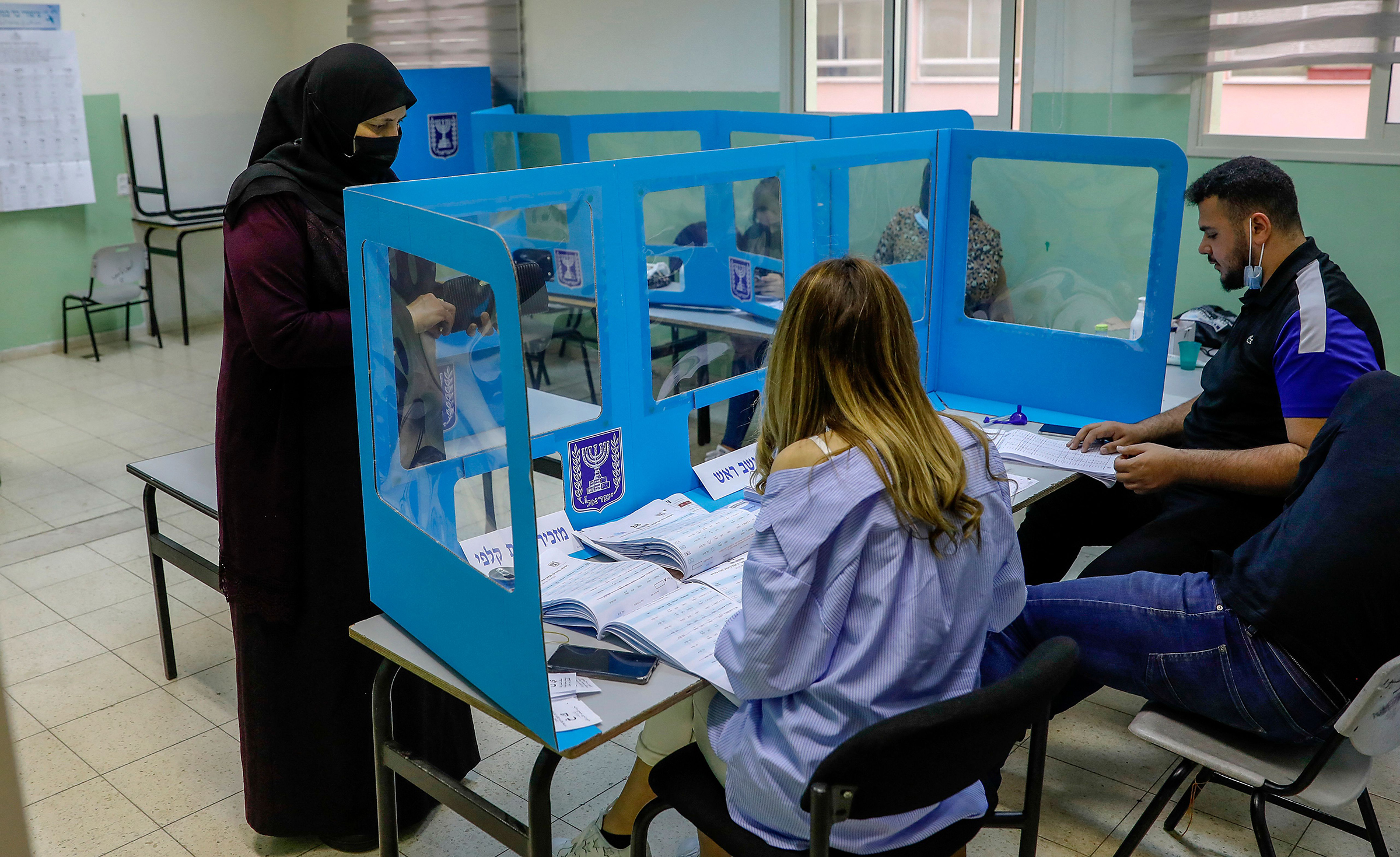 An Israeli Arab voter casts her ballot at a polling station in Kafr Manda, 16 kilometres northwest of Nazareth, on March 23, 2021. (Ahmad Gharabli—AFP/Getty Images)