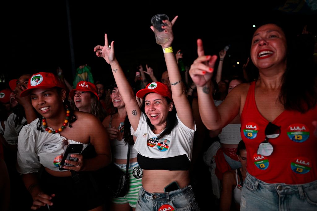 Supporters of Brazilian former President and candidate for the leftist Workers Party Luiz Inacio Lula da Silva celebrate while watching the vote count of the presidential run-off election at Largo Sao Francisco da Prainha in Rio de Janeiro, Brazil, on Oct. 30, 2022. (Mauro Pimental—AFP/Getty Images)