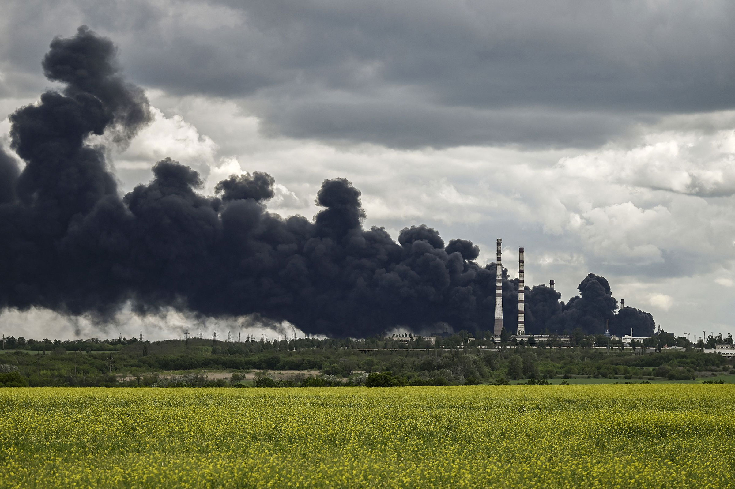 Smoke rises from an oil refinery after an attack outside the city of Lysychansk in the eastern Ukranian region of Donbas, on May 22, 2022, on the 88th day of the Russian invasion of Ukraine. (Aris Messinis—AFP/Getty Images)