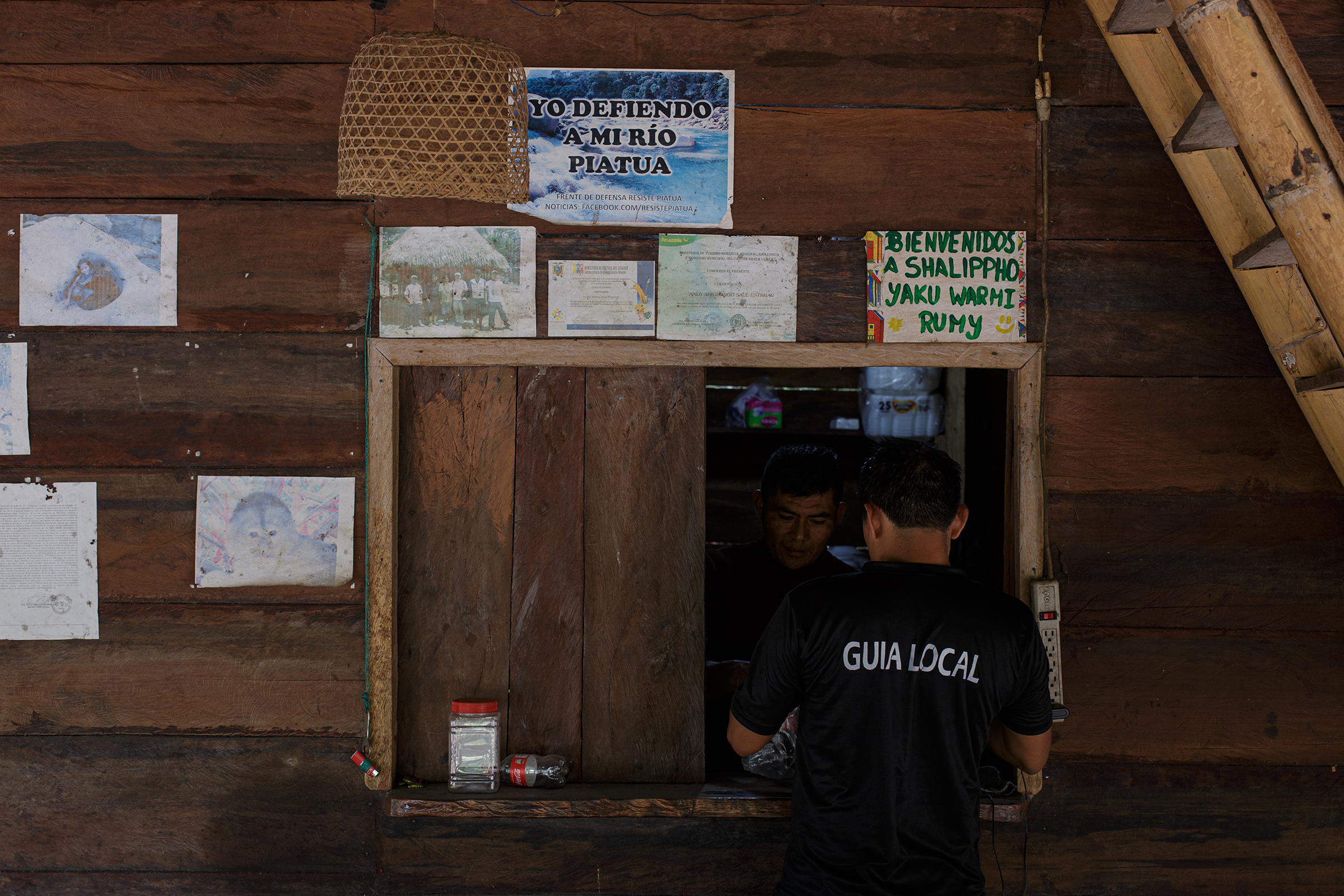 A sign in a local tourist center reading “I defend my Piatúa River.” (Andrés Yépez for TIME)