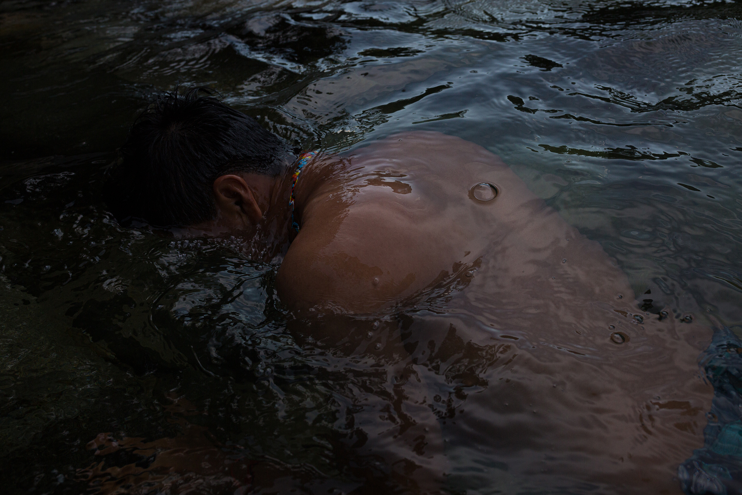 Alexis Grefa, a Kichwa Indigenous activist, takes a dip in the Piatúa River, which he seeks to protect. (Andrés Yépez for TIME)