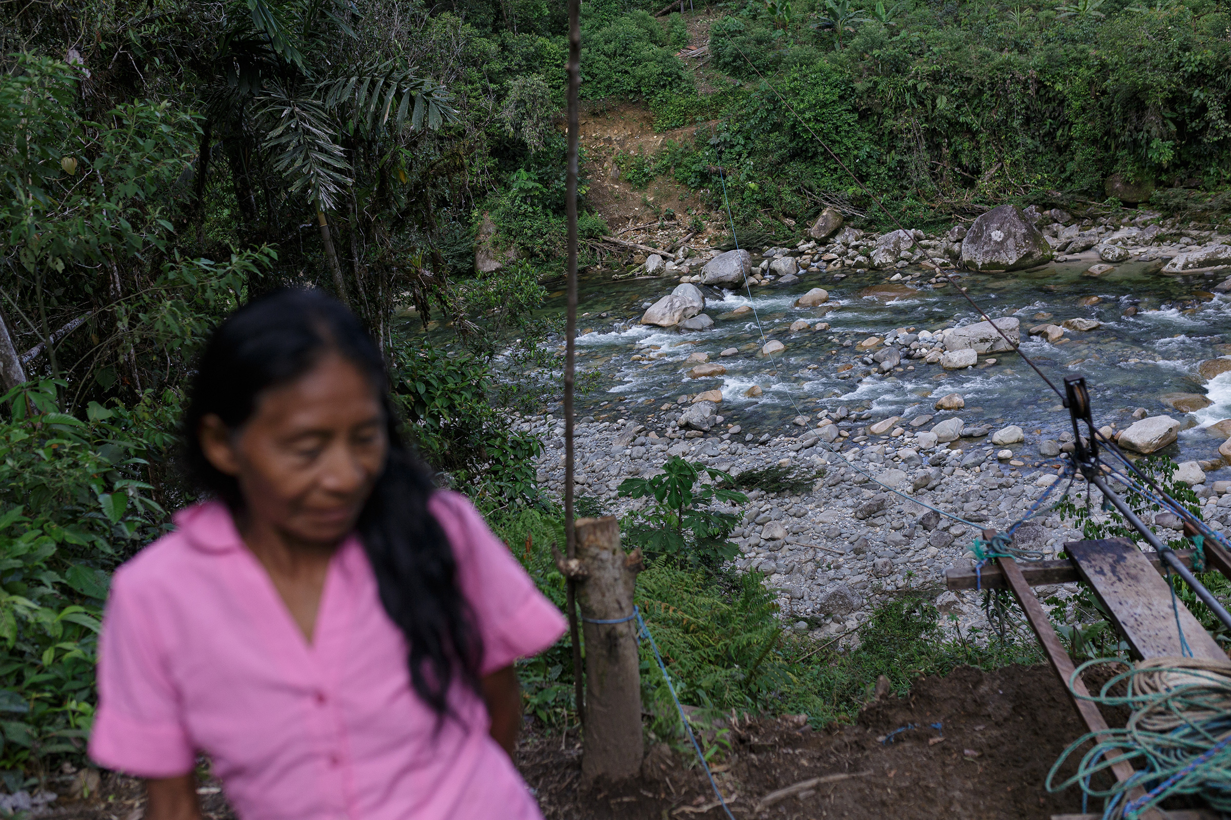 Mónica Tanguila, wife of Clemente Grefa, on the banks near a cable car connecting communities on opposite sides of the river. (Andrés Yépez for TIME)