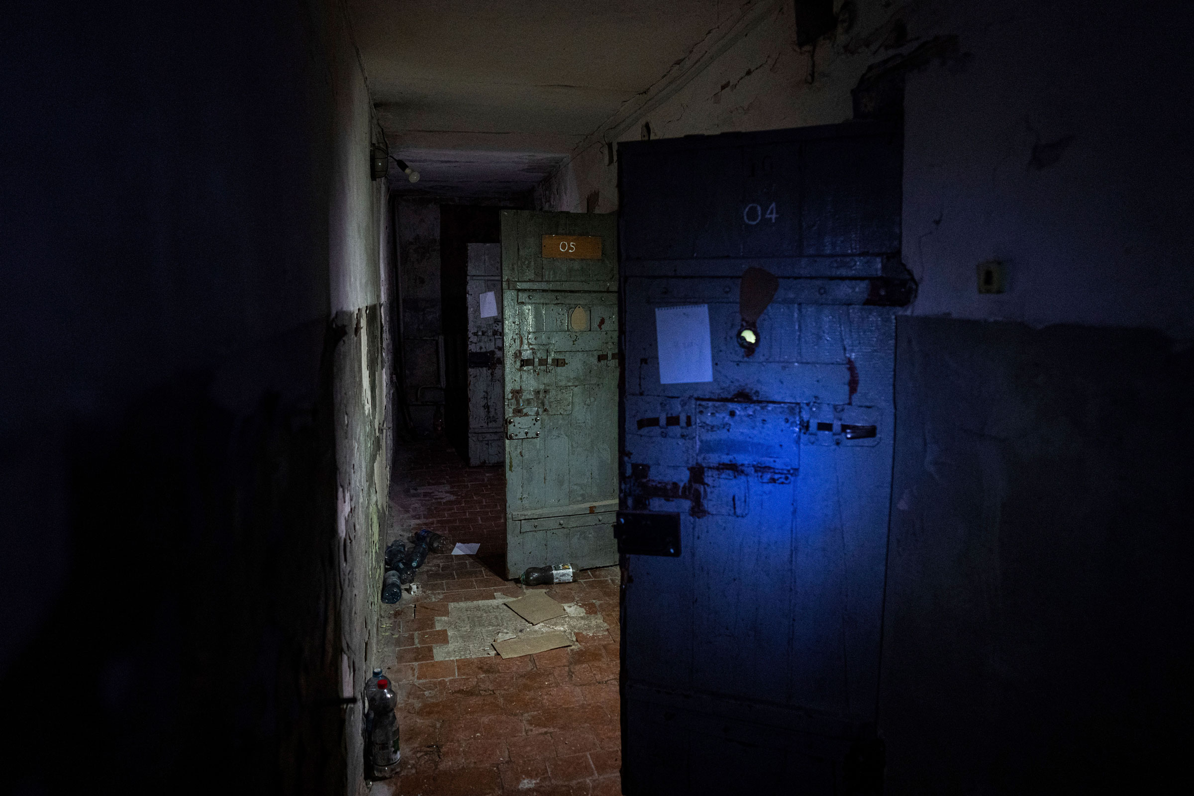 Holding cells are visible in a basement of a police station that was used by Russian forces to detain and torture Ukrainians in the recently liberated town of Izium, Ukraine, on Sept. 22, 2022. (Evgeniy Maloletka—AP)