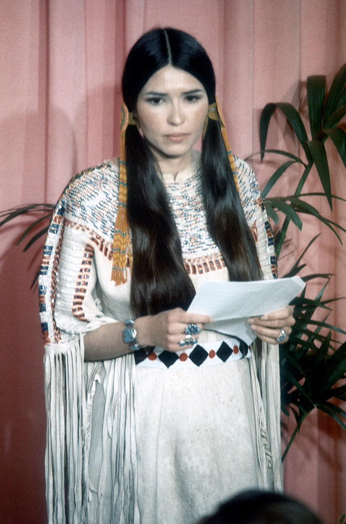 Sacheen Littlefeather holds a written statement from actor Marlon Brando refusing his Best Actor Oscar on stage at the Academy Awards on March 27, 1973 in Los Angeles, California. (Michael Ochs Archvies–Getty Images)