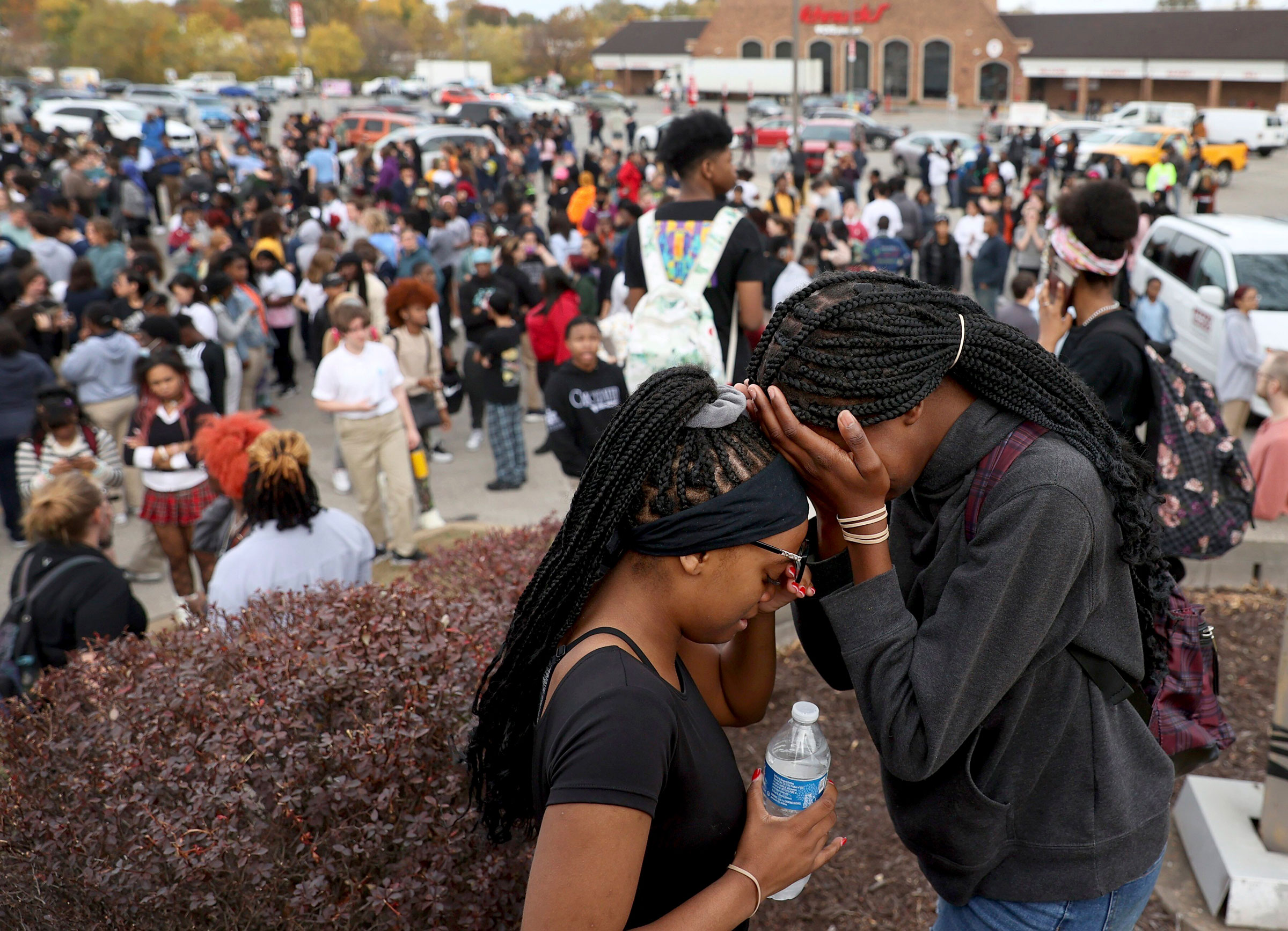 Students stand in a parking lot near the Central Visual &amp; Performing Arts High School after a reported shooting at the school in St. Louis, on Monday, Oct. 24, 2022. (David Carson—St. Louis Post-Dispatch/AP)