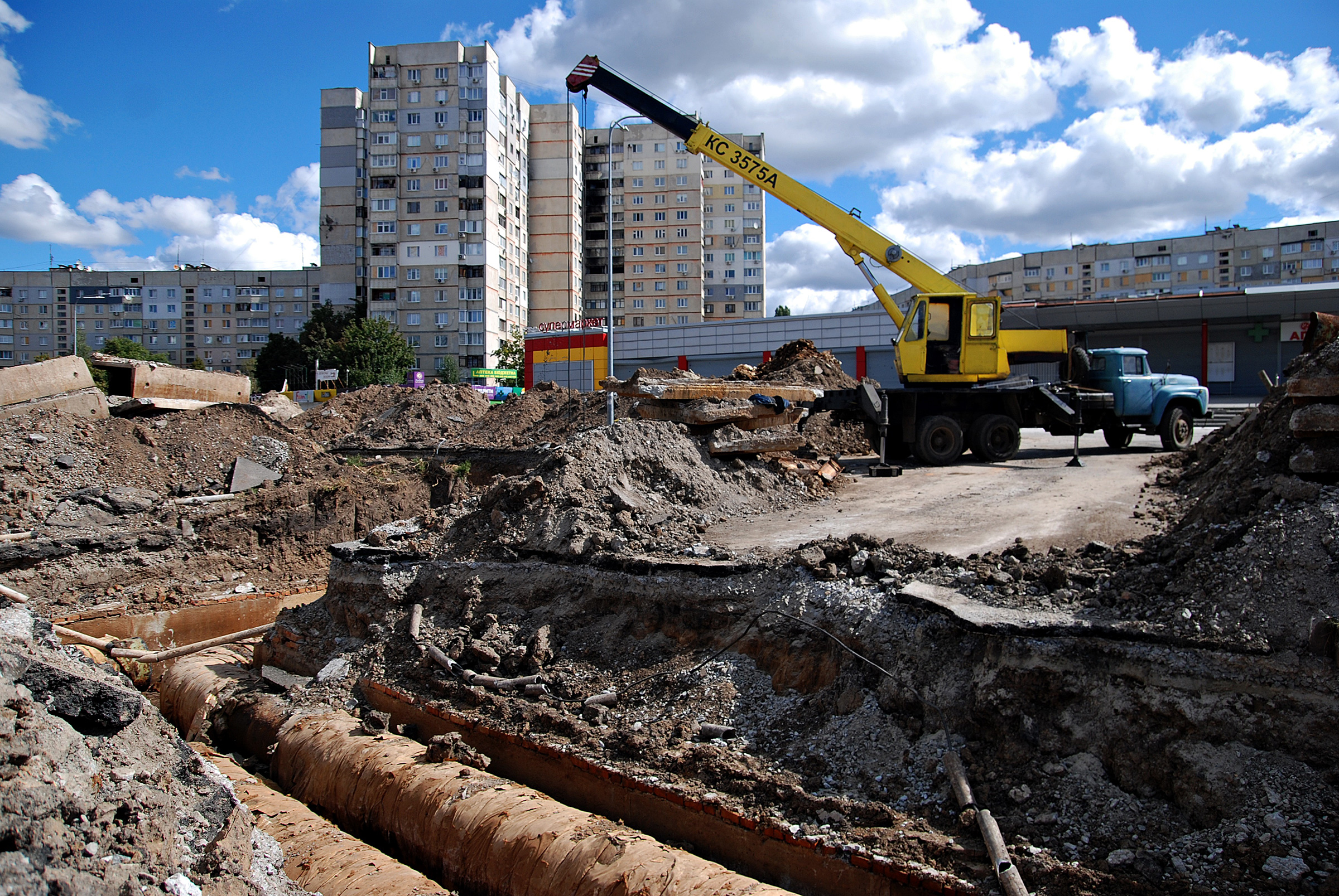 The truck crane stands next to the section of the heating main where utility workers replace old pipes on Sept. 9 in Kharkiv, Ukraine. The city authorities organized the replacement of heating pipes to reduce heat losses in the Saltivka district, despite daily shelling by Russian troops. (Oleksandr Lapshyn—Global Images Ukraine/Getty Images)