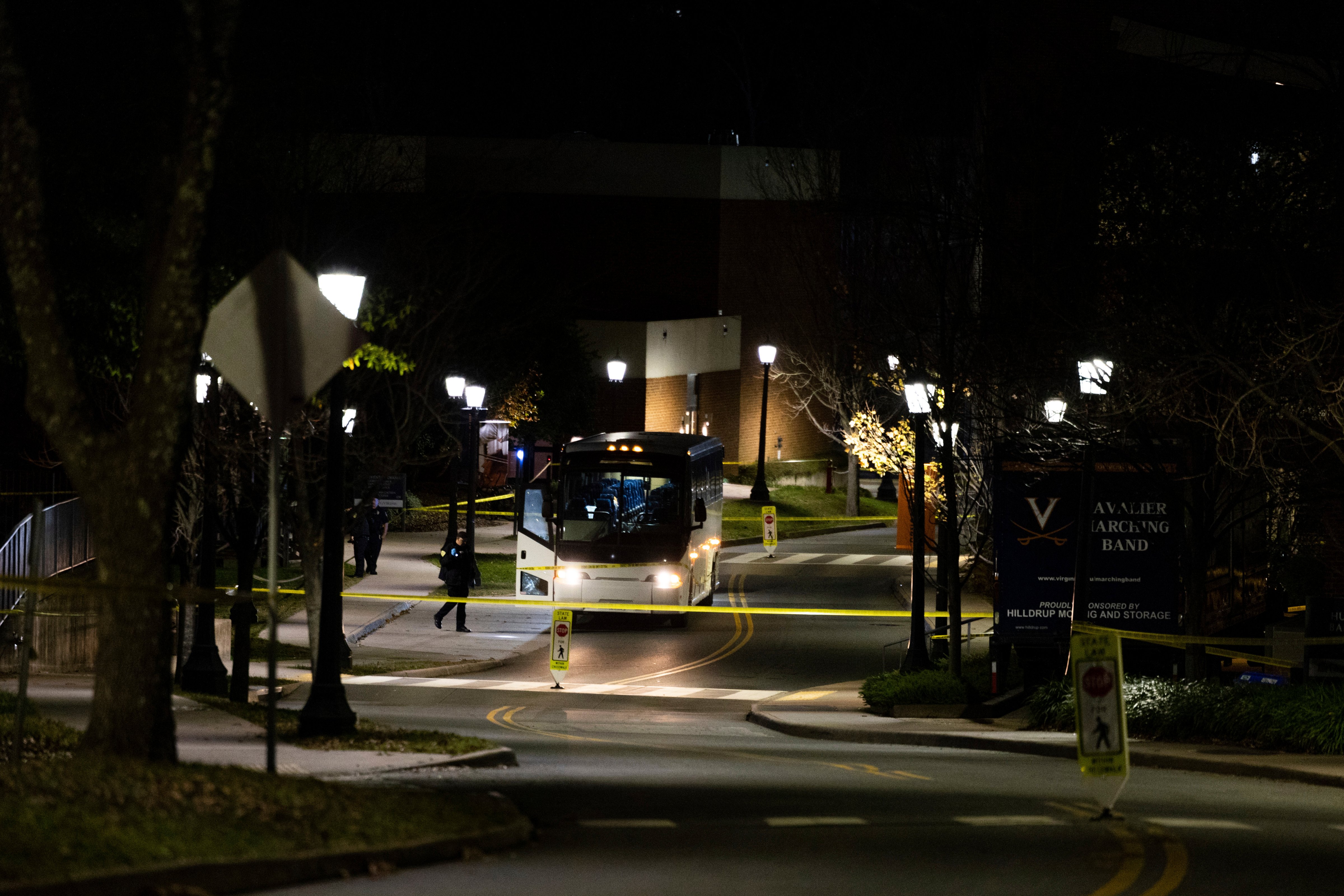 A bus idles behind police tape during an active shooter situation at the University of Virginia in Charlottesville, Va., on Monday, Nov. 14, 2022. (Mike Kropf – The Daily Progress via AP)