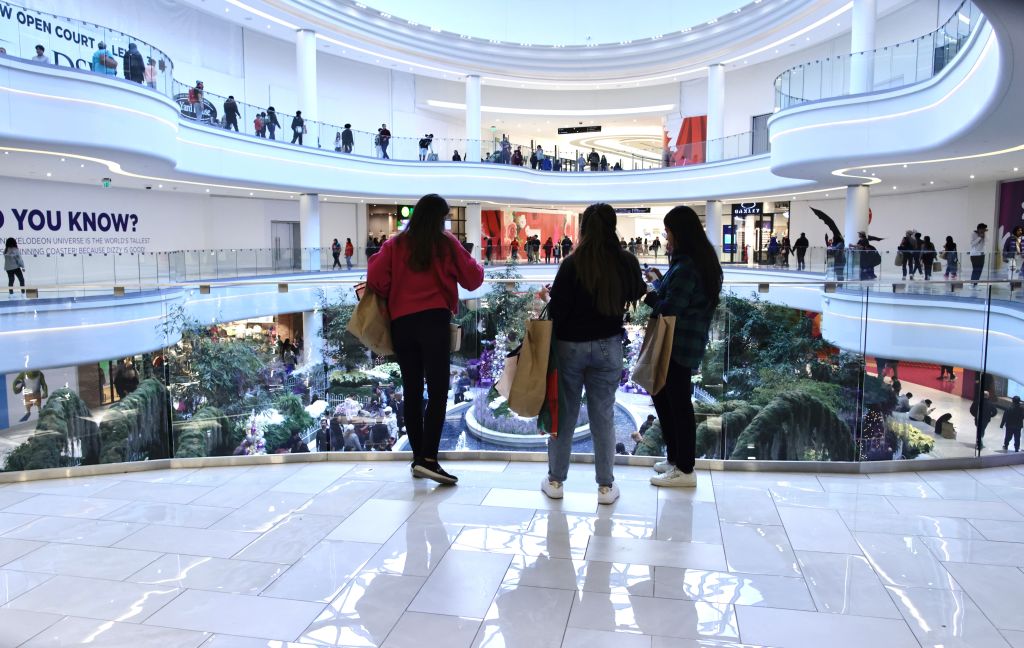 Women carry shopping bags as customers visit the American Mall dream mall during Black Friday in East Rutherford, New Jersey, on on November 25, 2022. (Kena Betancur—Getty Images)