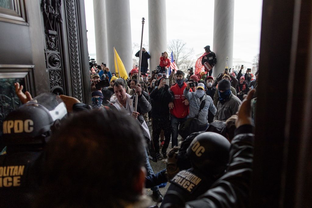 Police intervenes in US President Donald Trumps supporters who breached security and attempt to enter the Capitol building in Washington D.C., United States on January 06, 2021. (Mostafa Bassim-Anadolu Agency)