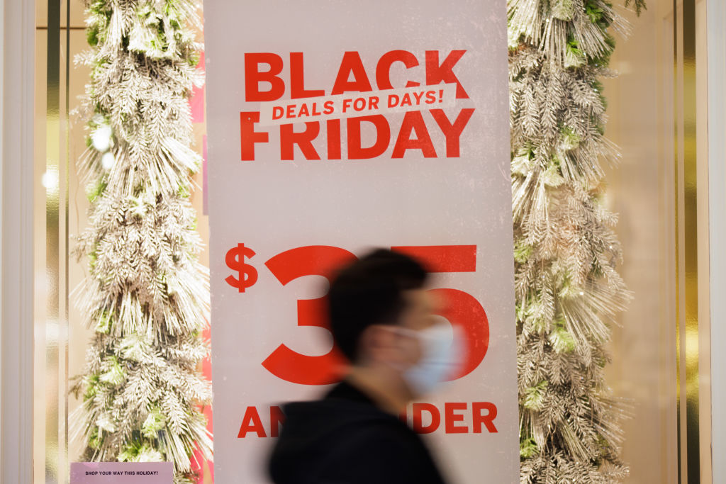 A shopper walks by a store banner promoting Black Friday deals on Friday, Nov. 26, 2021, in the Westfield Oakridge mall in San Jose, Calif. (Dai Sugano—MediaNews Group/The Mercury News/Getty Images)