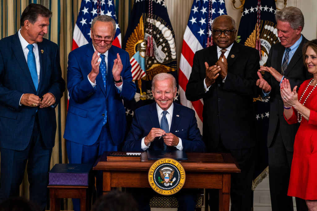 US President Joe Biden after signing into law H.R. 5376, the Inflation Reduction Act of 2022 (climate change and health care bill) in the State Dining Room of the White House on Tuesday August 16, 2022. From left, Sen. Joe Manchin (D-W.VA), Senate Majority Leader Chuck Schumer (D-NY), House Majority Whip Rep. James Clyburn (D-SC), Rep. Frank Pallone (D-NJ), and Rep. Kathy Castor (D-FL). (Demetrius Freeman-The Washington Post)