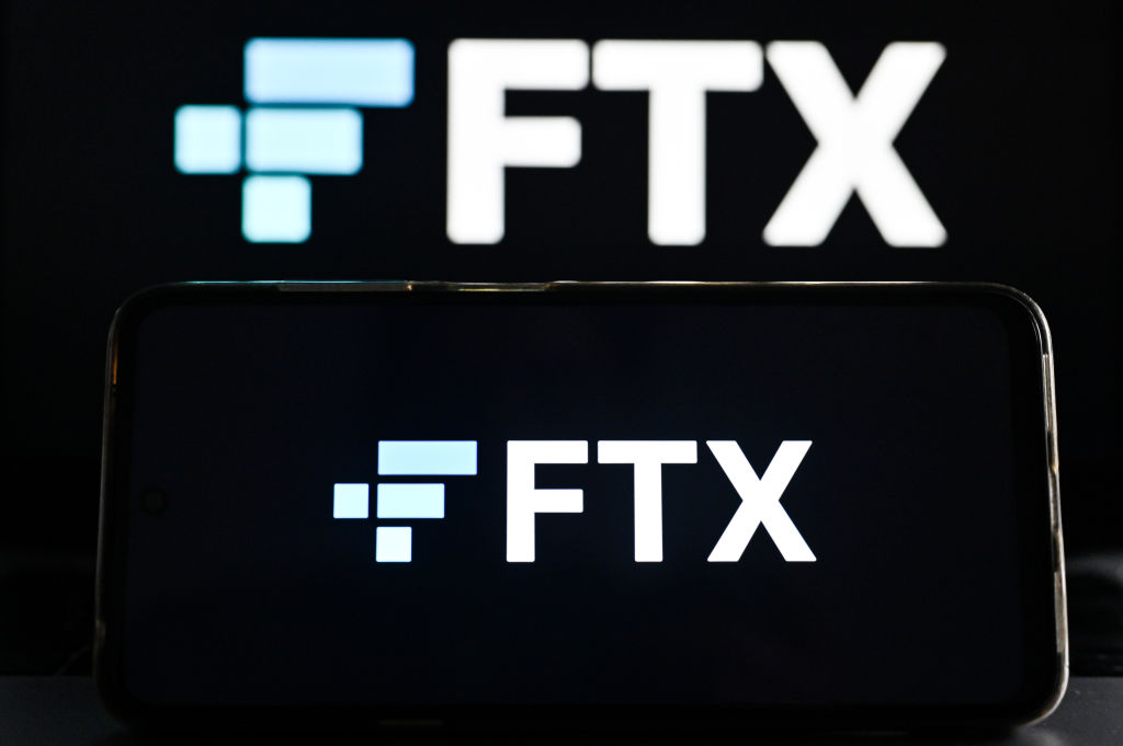 In this photo illustration FTX logo is displayed on a smartphone screen and in the background. (Omar Marques-SOPA Images/LightRocket)