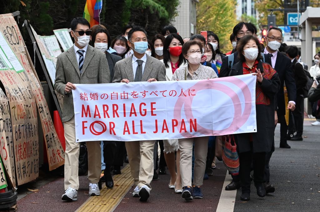 Plaintiffs and their supporters head to the Tokyo District Court on November 30, 2022, for the ruling on a lawsuit filed by same-sex couples seeking damages from the government arguing the ban on same-sex marriage is unconstitutional. (Kazuhiro Nogi—AFP/Getty Images)