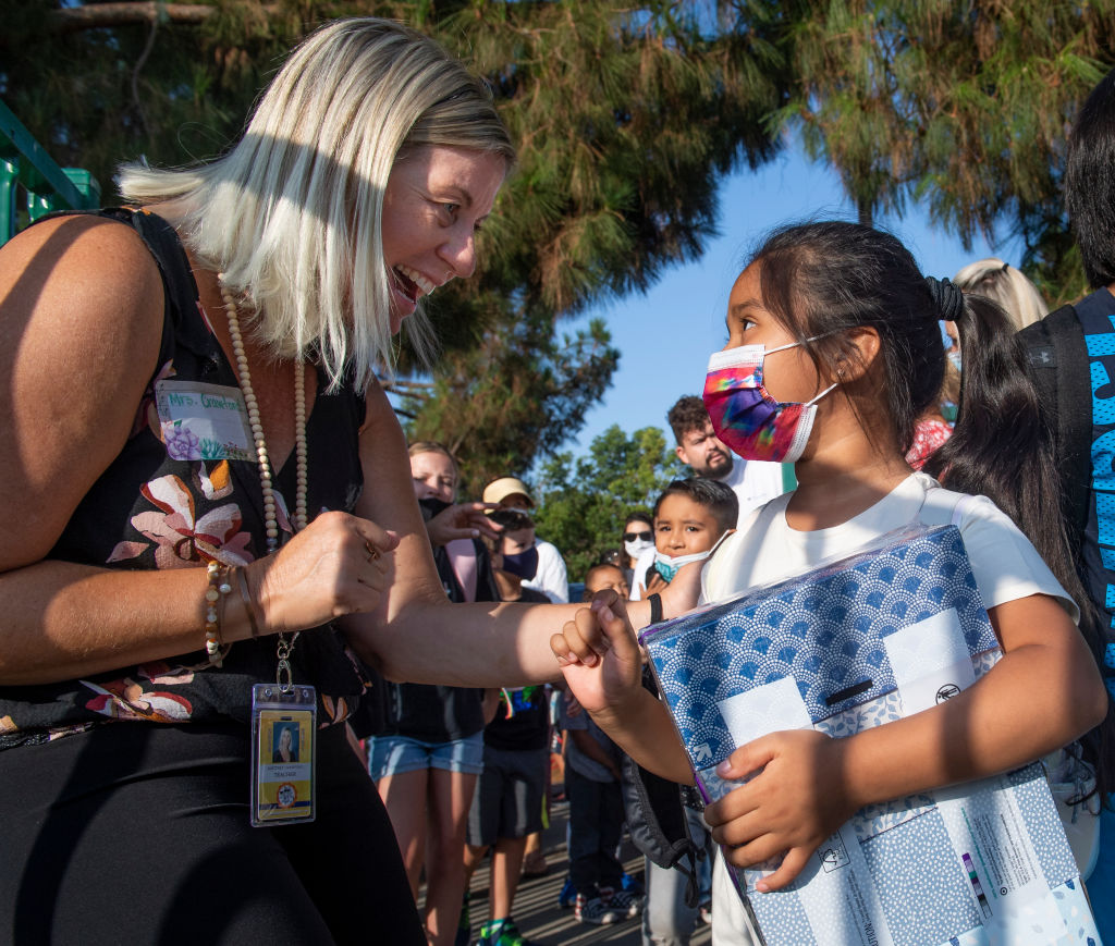 A student is greeted by her previous years teacher, Brittney Crawford, during the first day of school at Tustin Ranch Elementary School in Tustin, CA on Wednesday, August 11, 2021. (Paul Bersebach/MediaNews Group/Orange County Register)