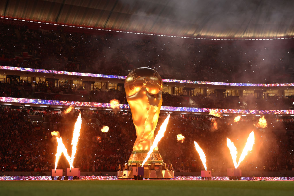 Pyrotechnics explode around a giant World Cup trophy before the match between Spain and Germany at Al Bayt Stadium in Al Khor, Qatar, Nov. 27, 2022. (Julian Finney/Getty Images)